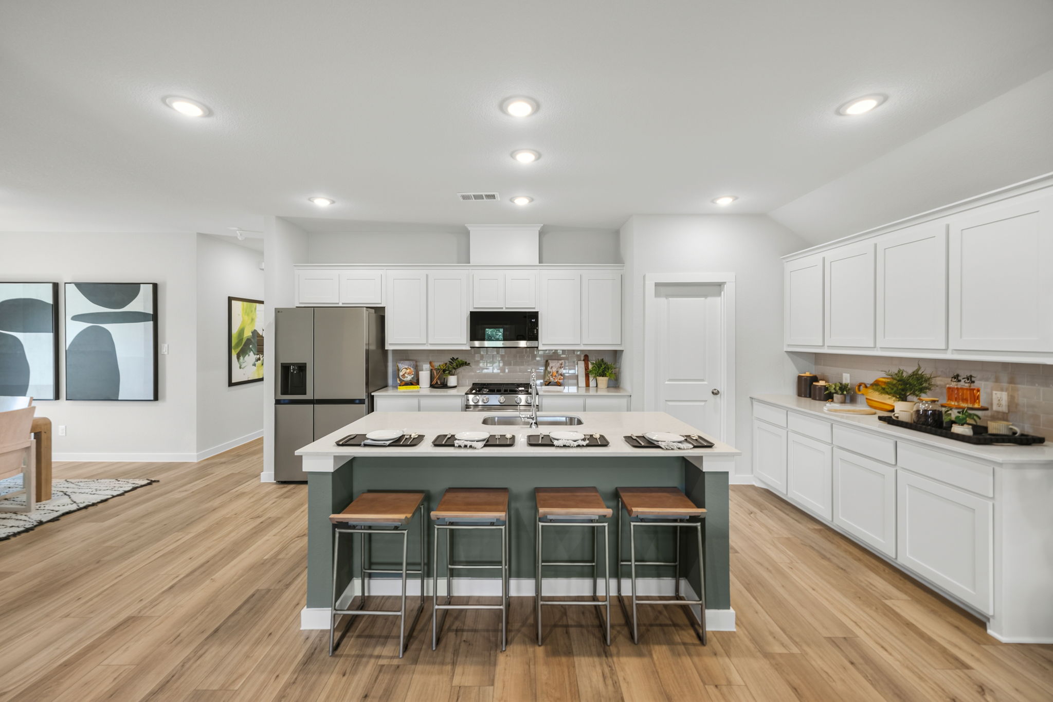 A kitchen with white cabinets.