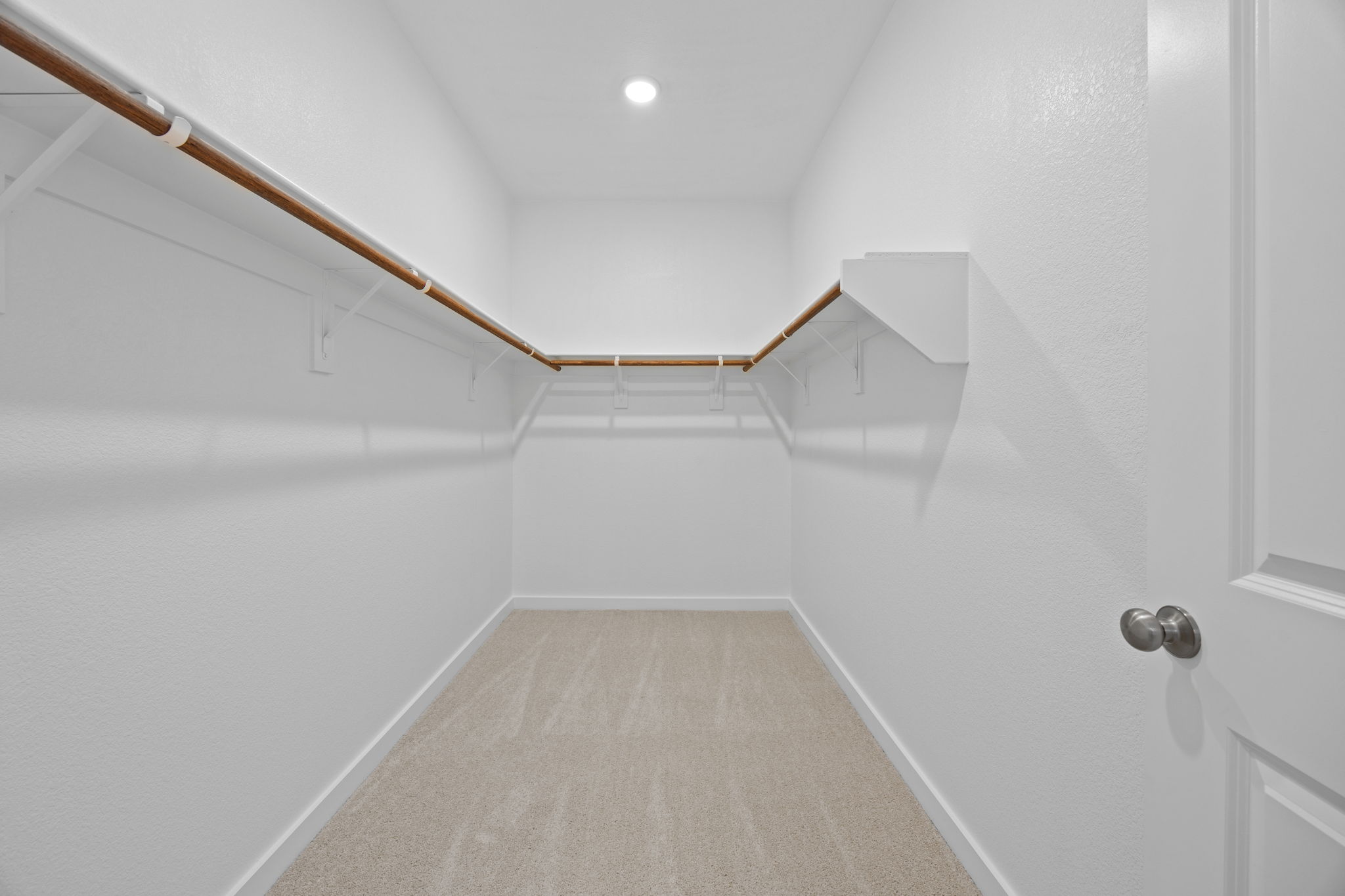 A hallway with white walls.