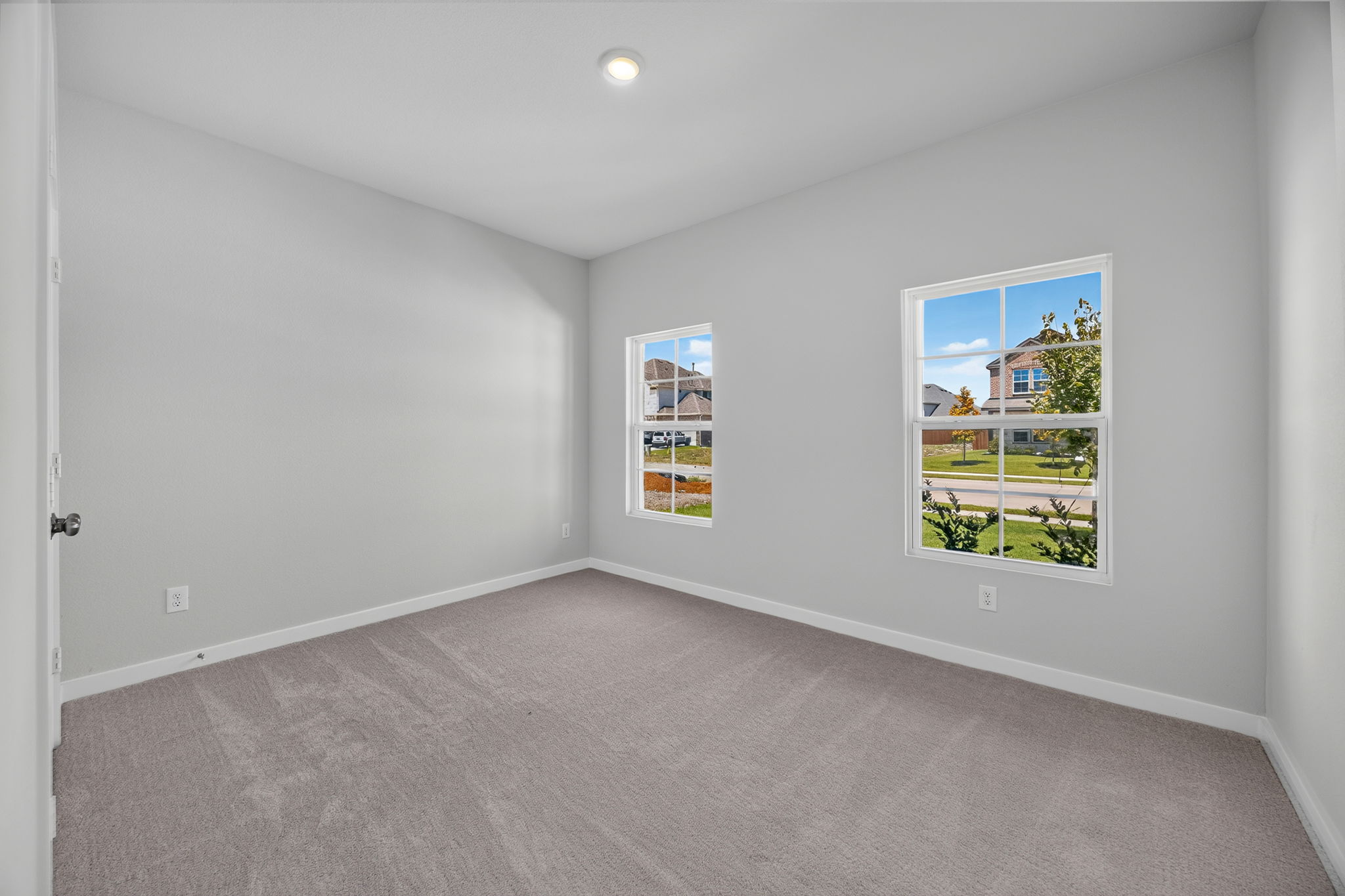 A room with a window and a carpet.