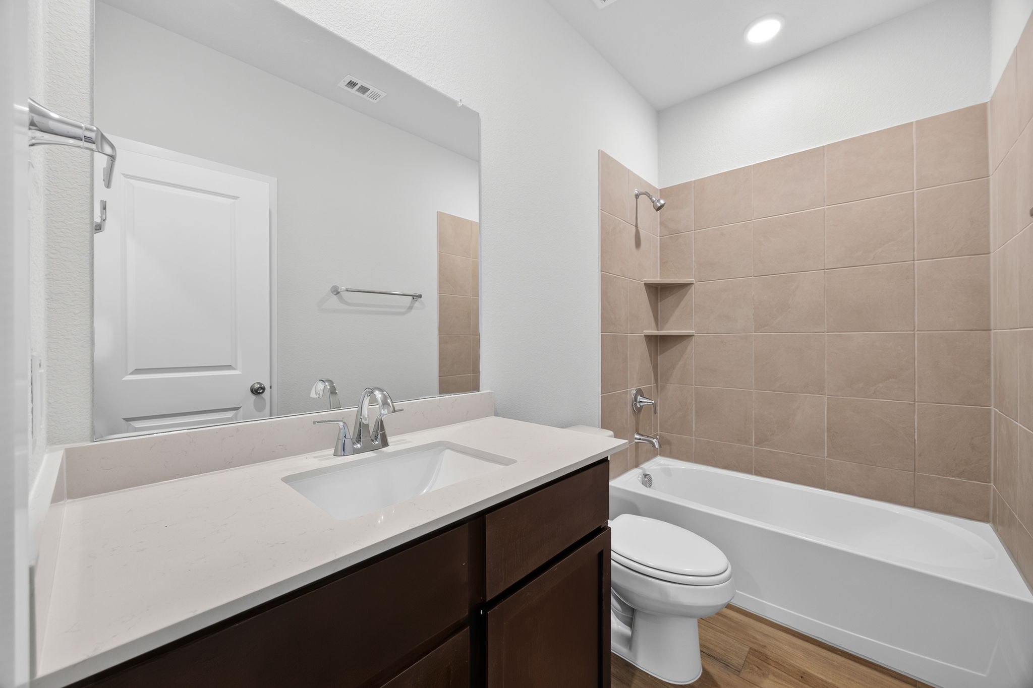A bathroom with a tub sink and toilet.