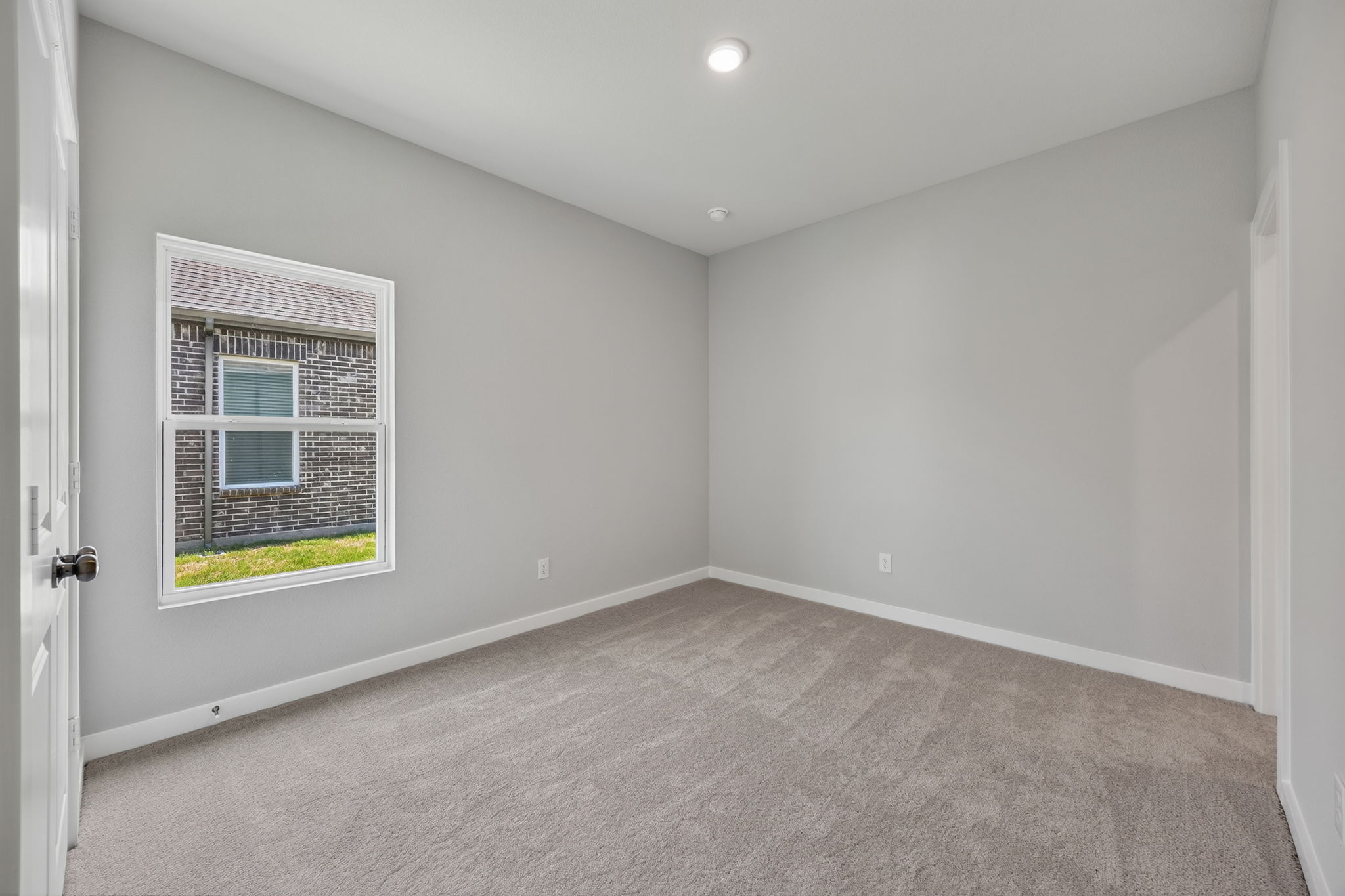 A room with a window and a door.