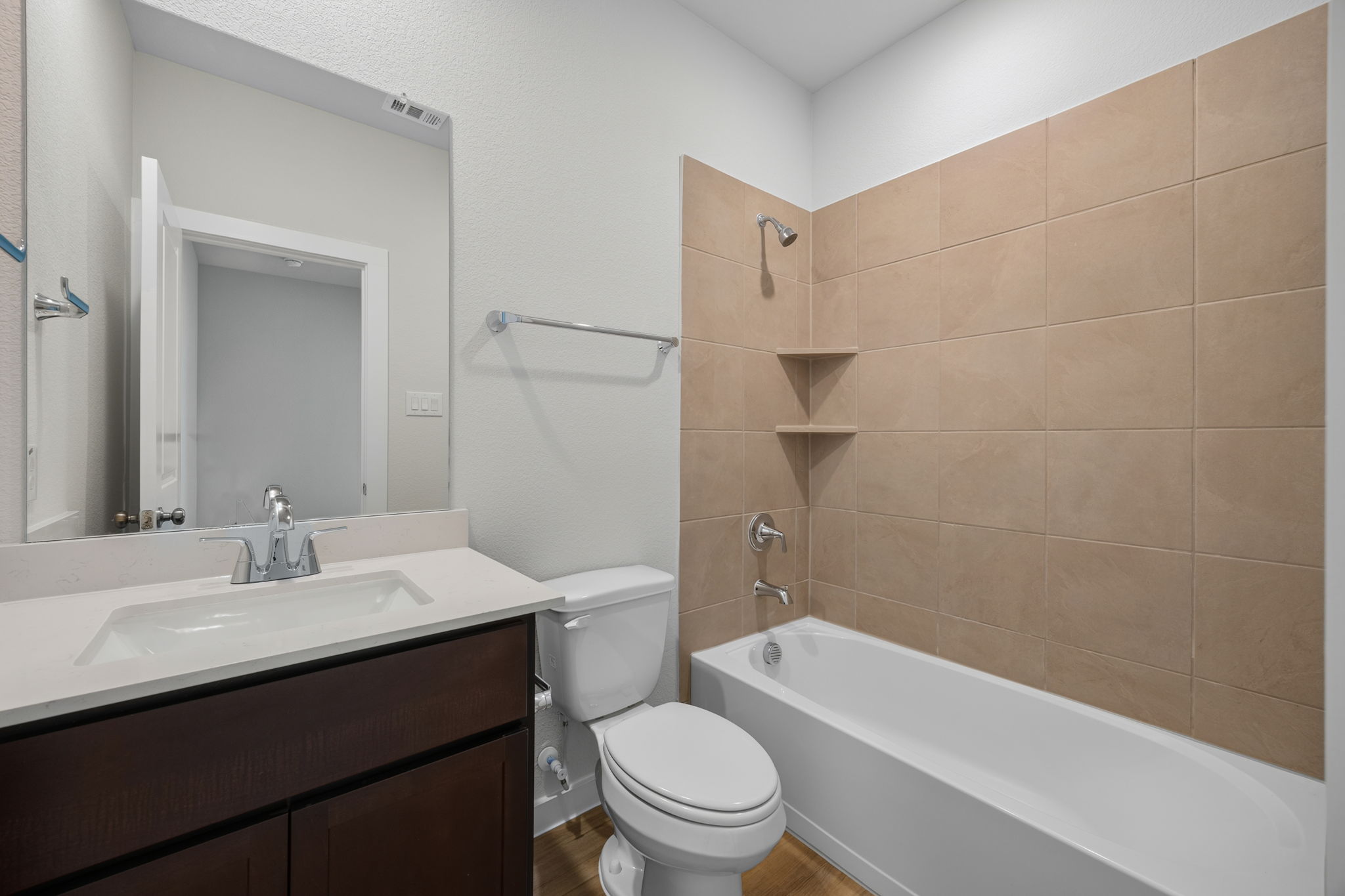 A bathroom with a tub toilet and sink.