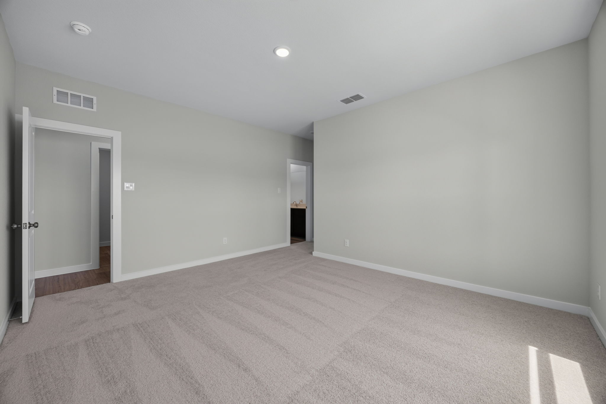 A hallway with white walls.