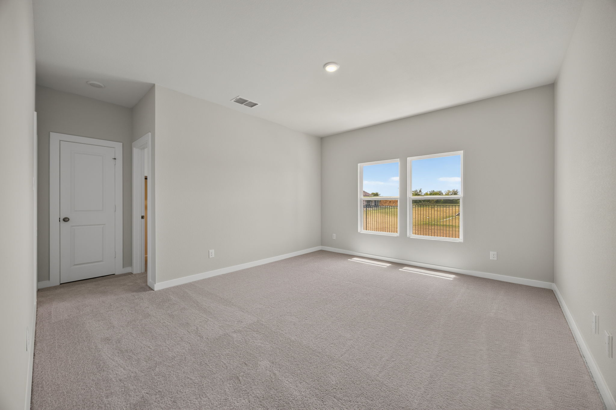 A room with a white door and a window.