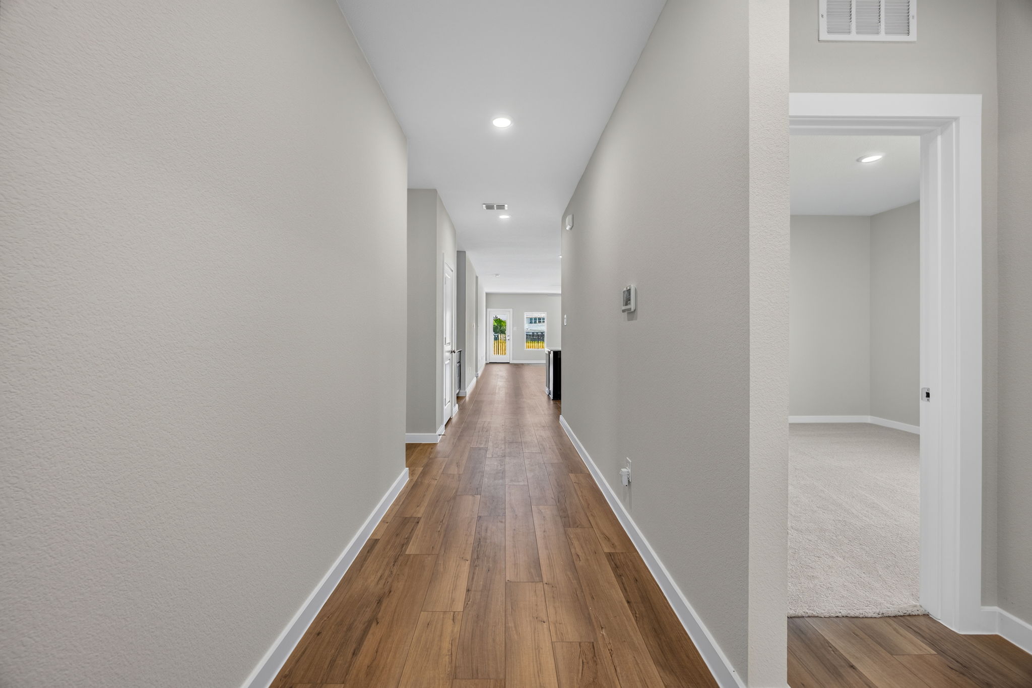 A long hallway with white walls.