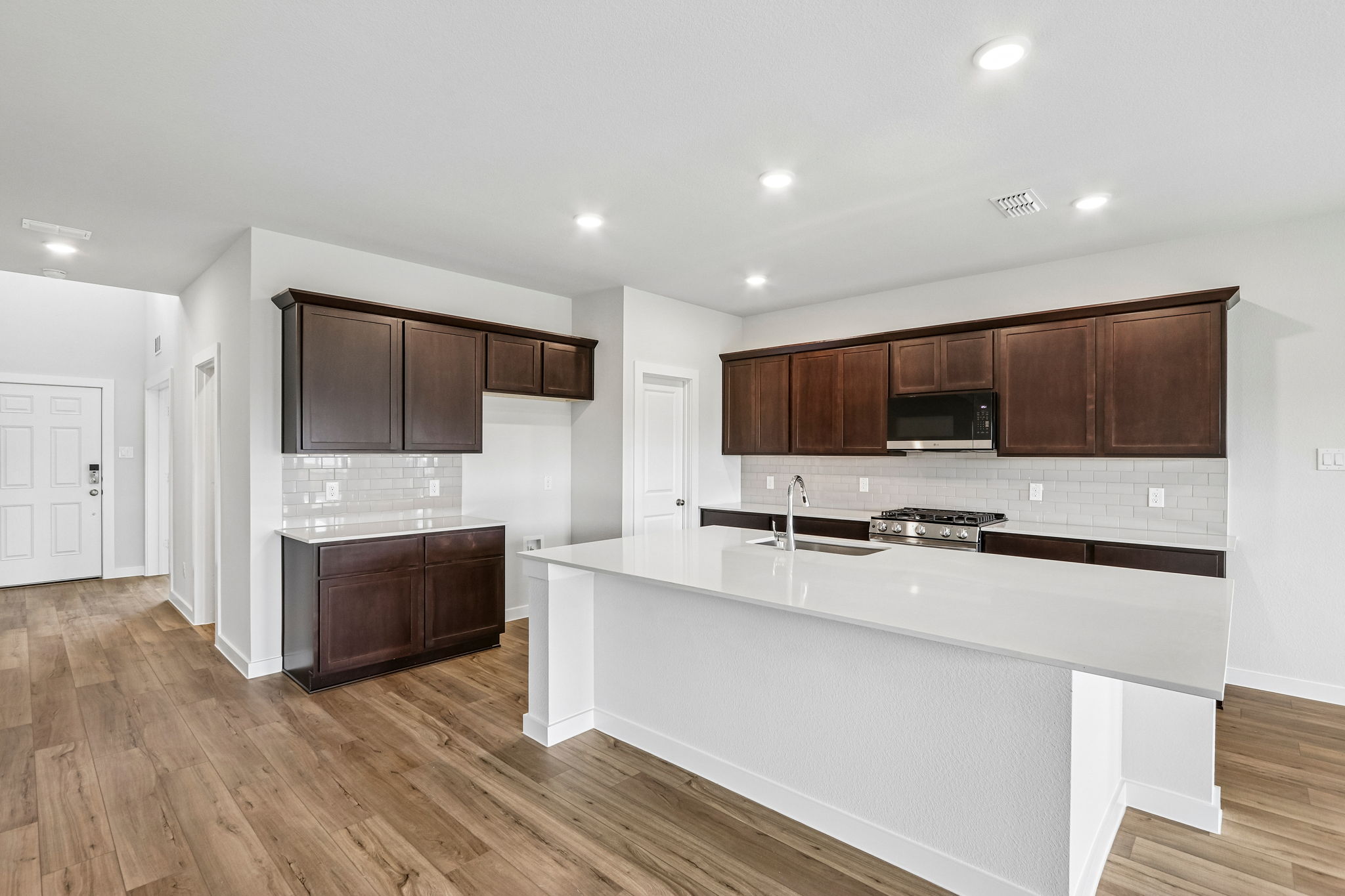 A kitchen with wooden cabinets.