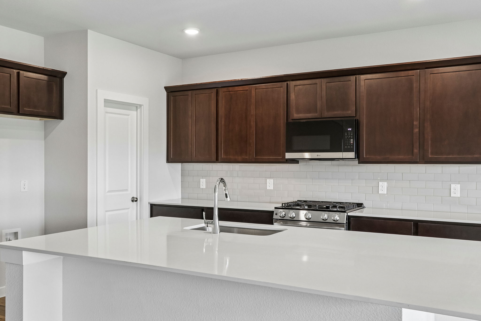 A kitchen with wooden cabinets.