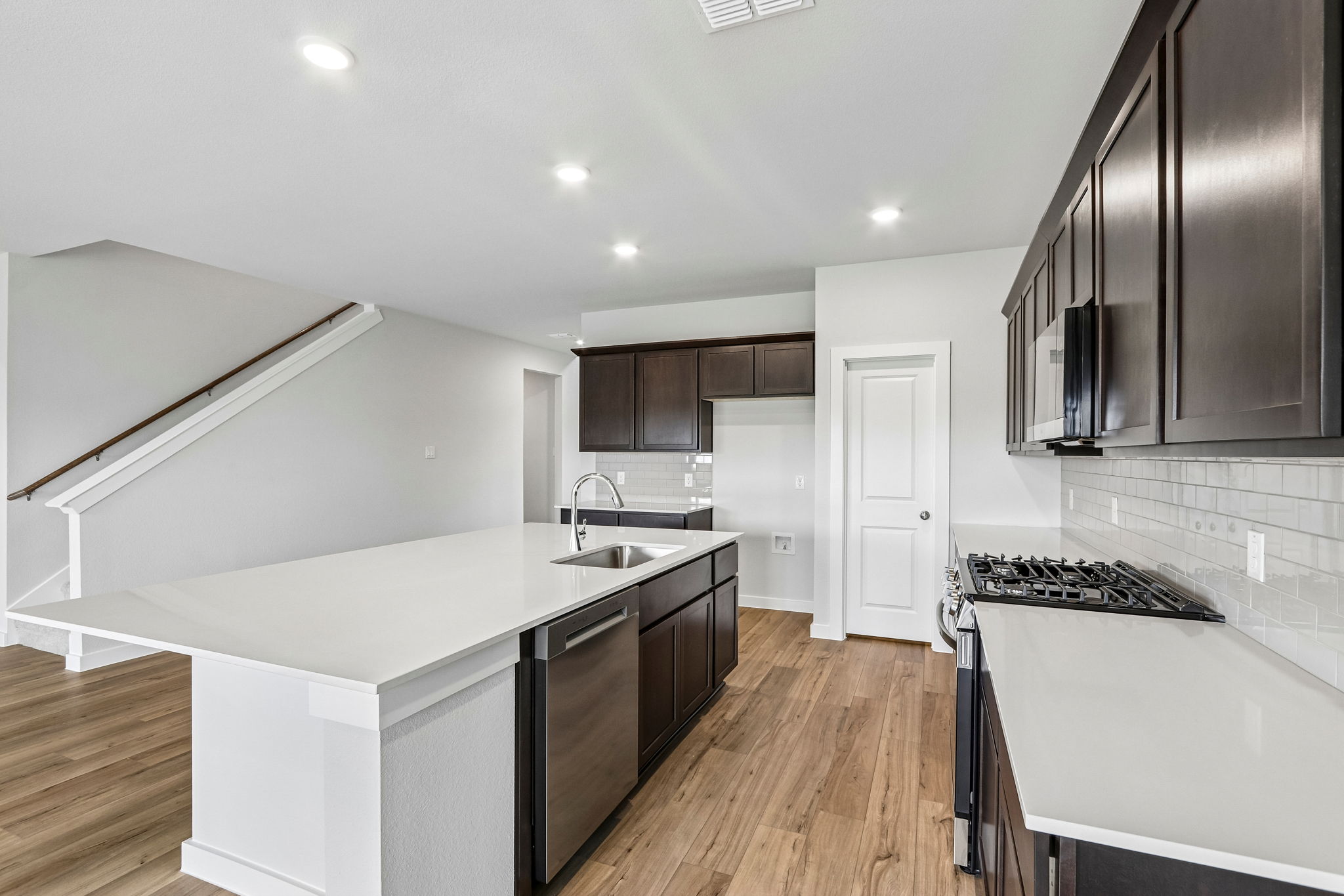 A kitchen with a tub and sink.