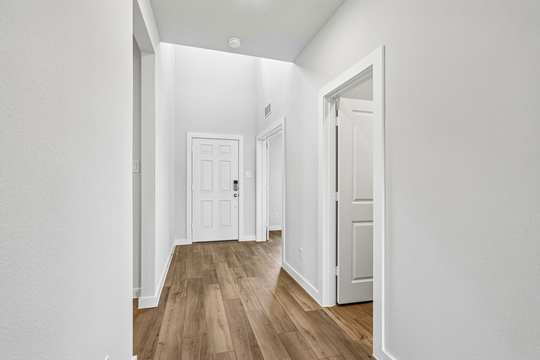 A hallway with white doors.