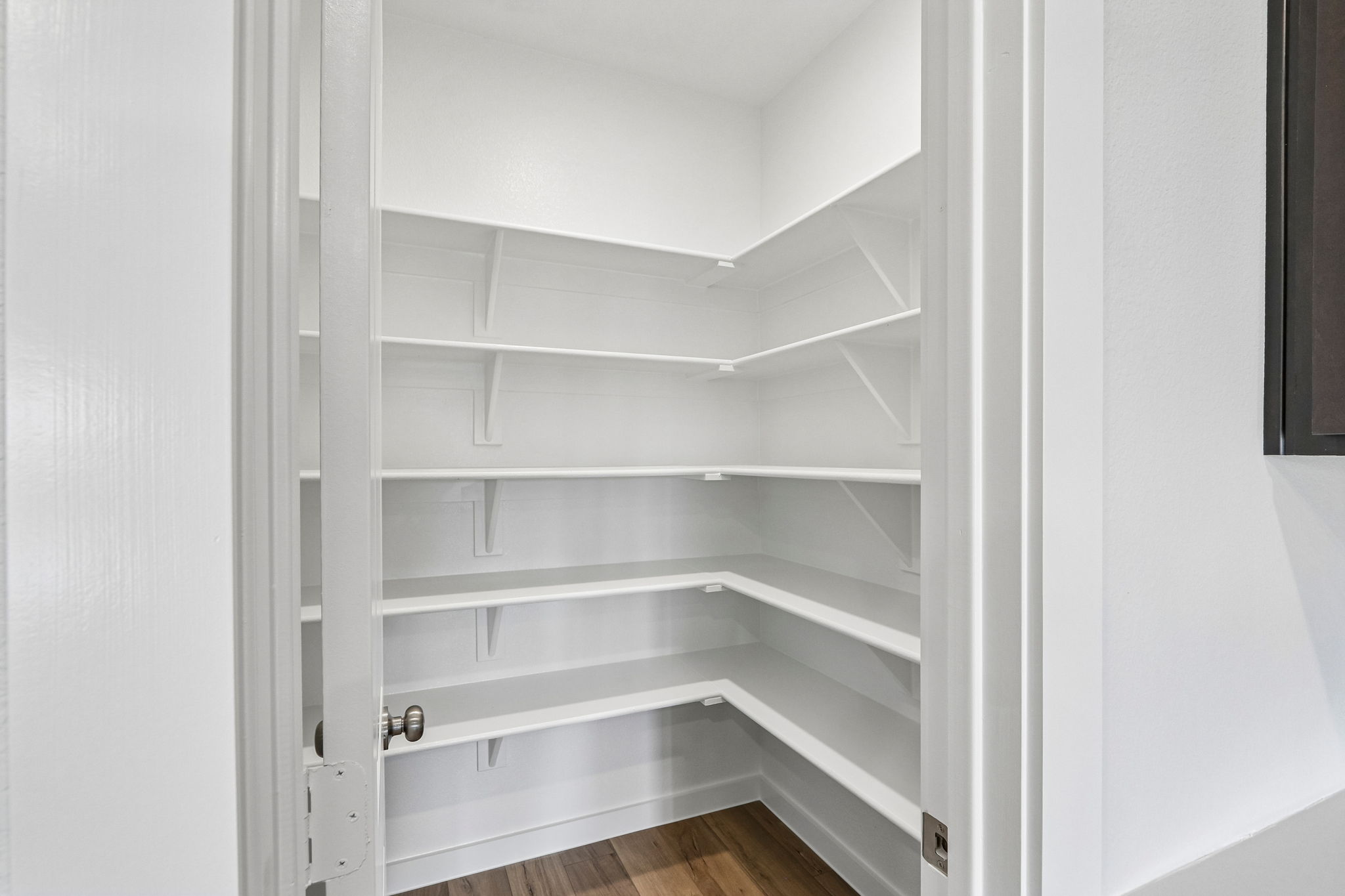A white staircase with a wooden floor.