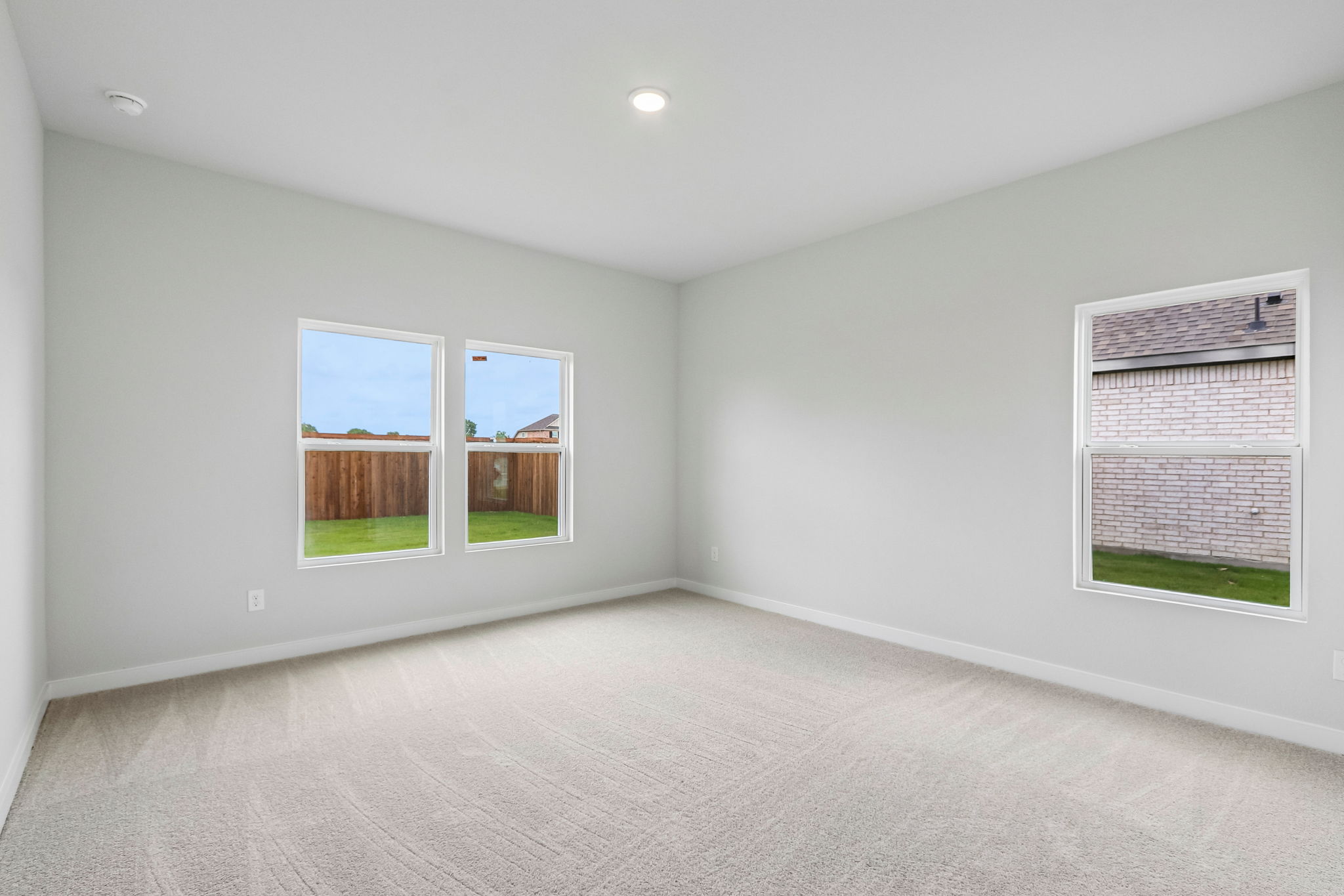A room with a window and a door with a view of the outside.