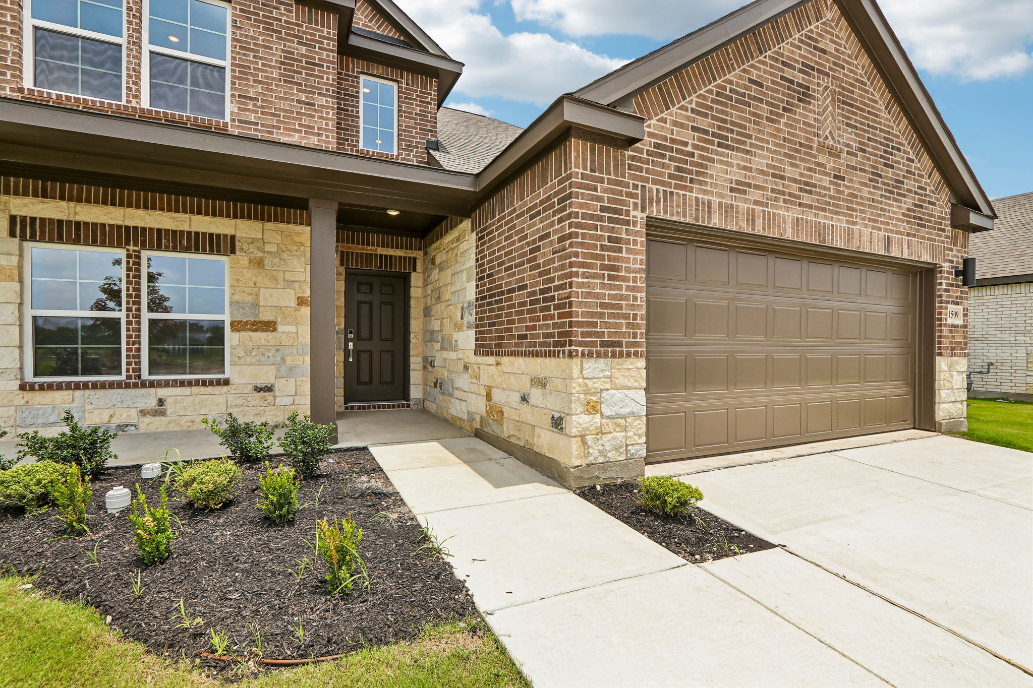 A brick house with a garage.