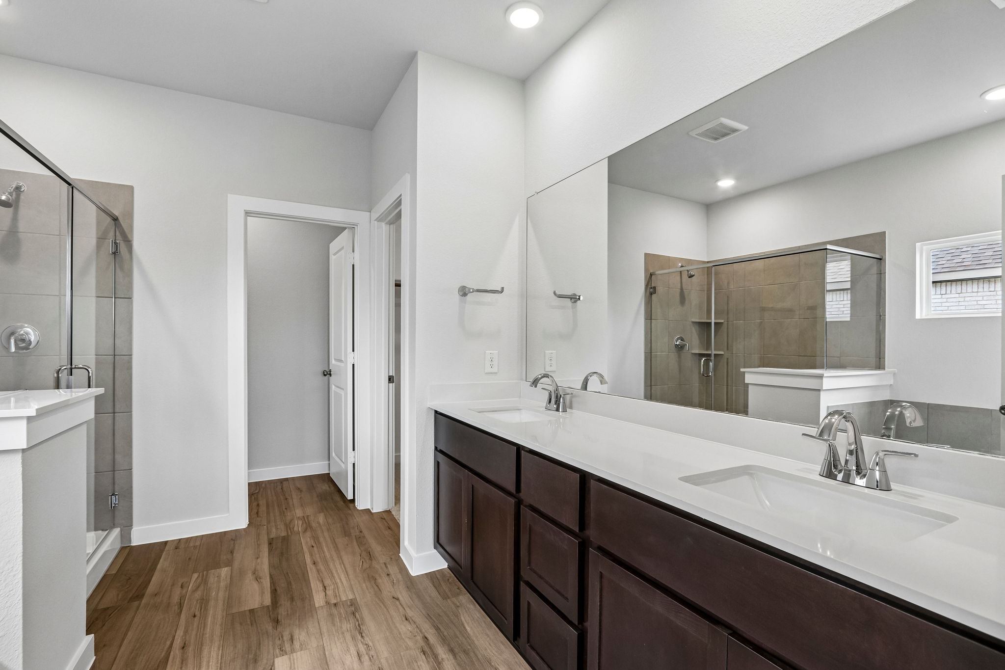 A bathroom with a large mirror.
