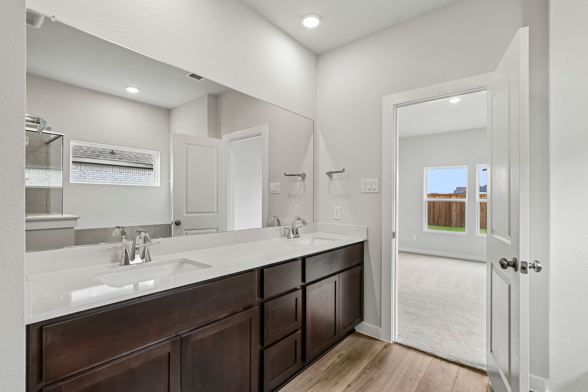 A bathroom with a large mirror.