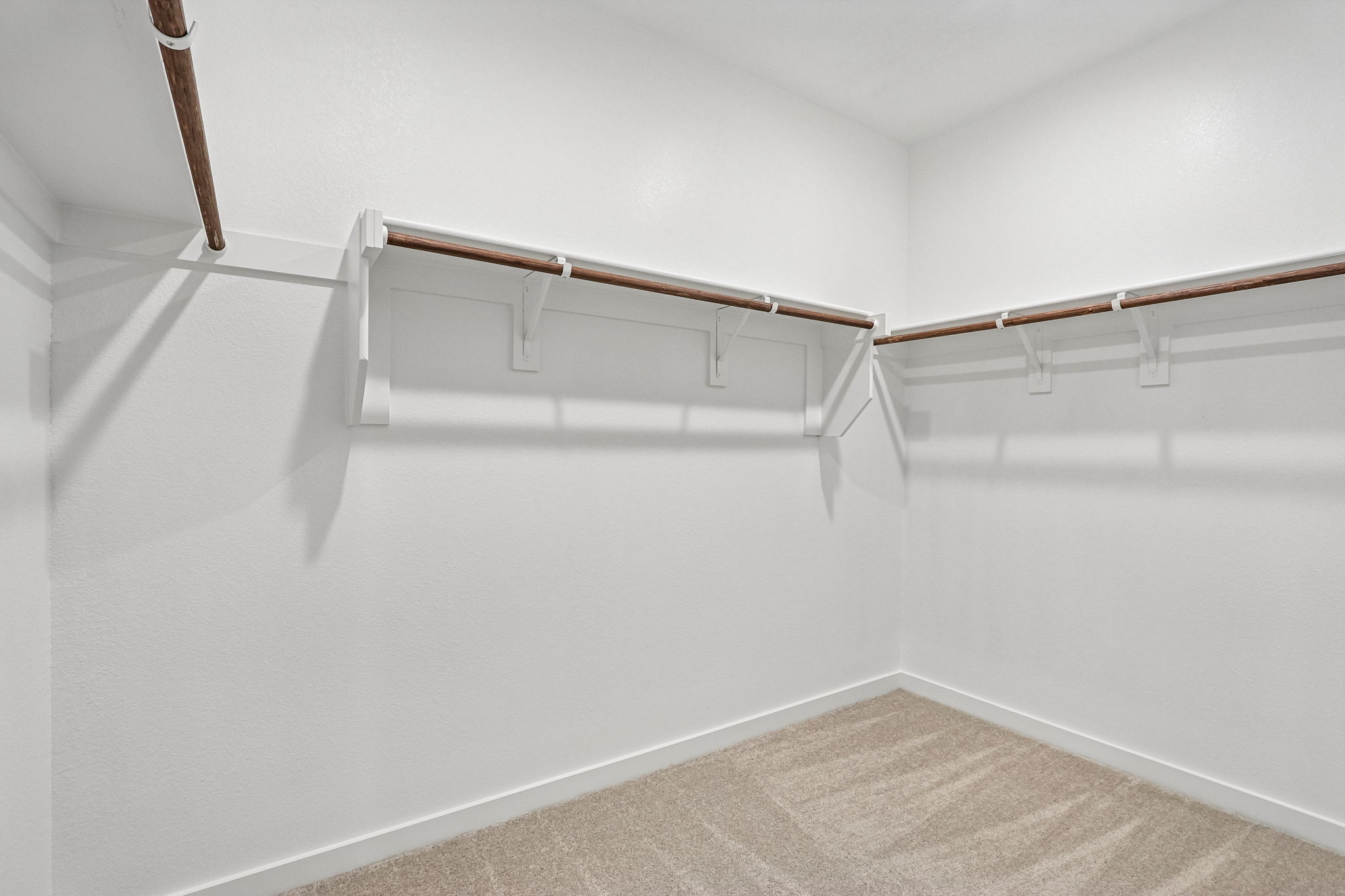 A white wall with a wooden railing.