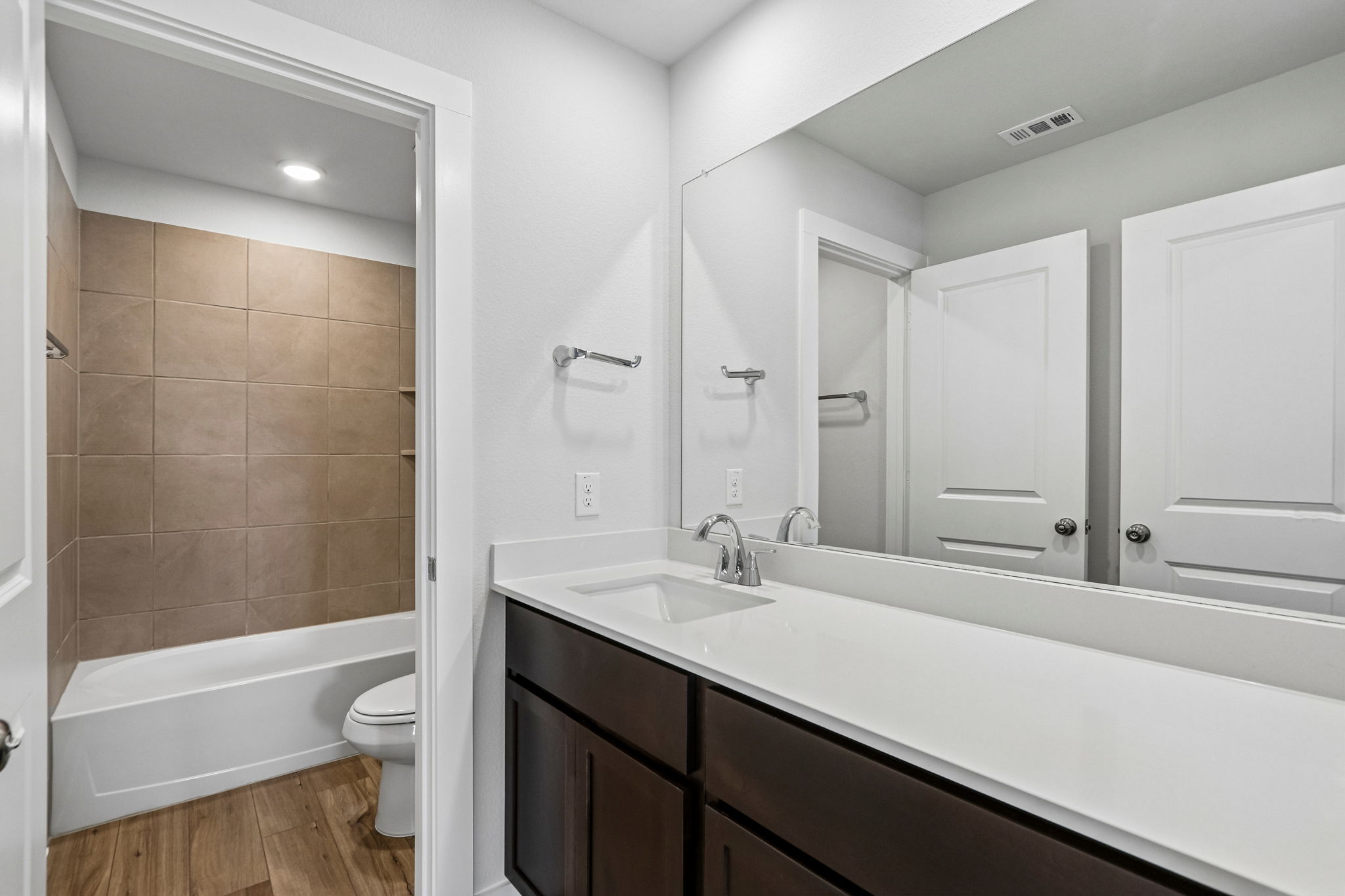 A bathroom with a tub sink and toilet.