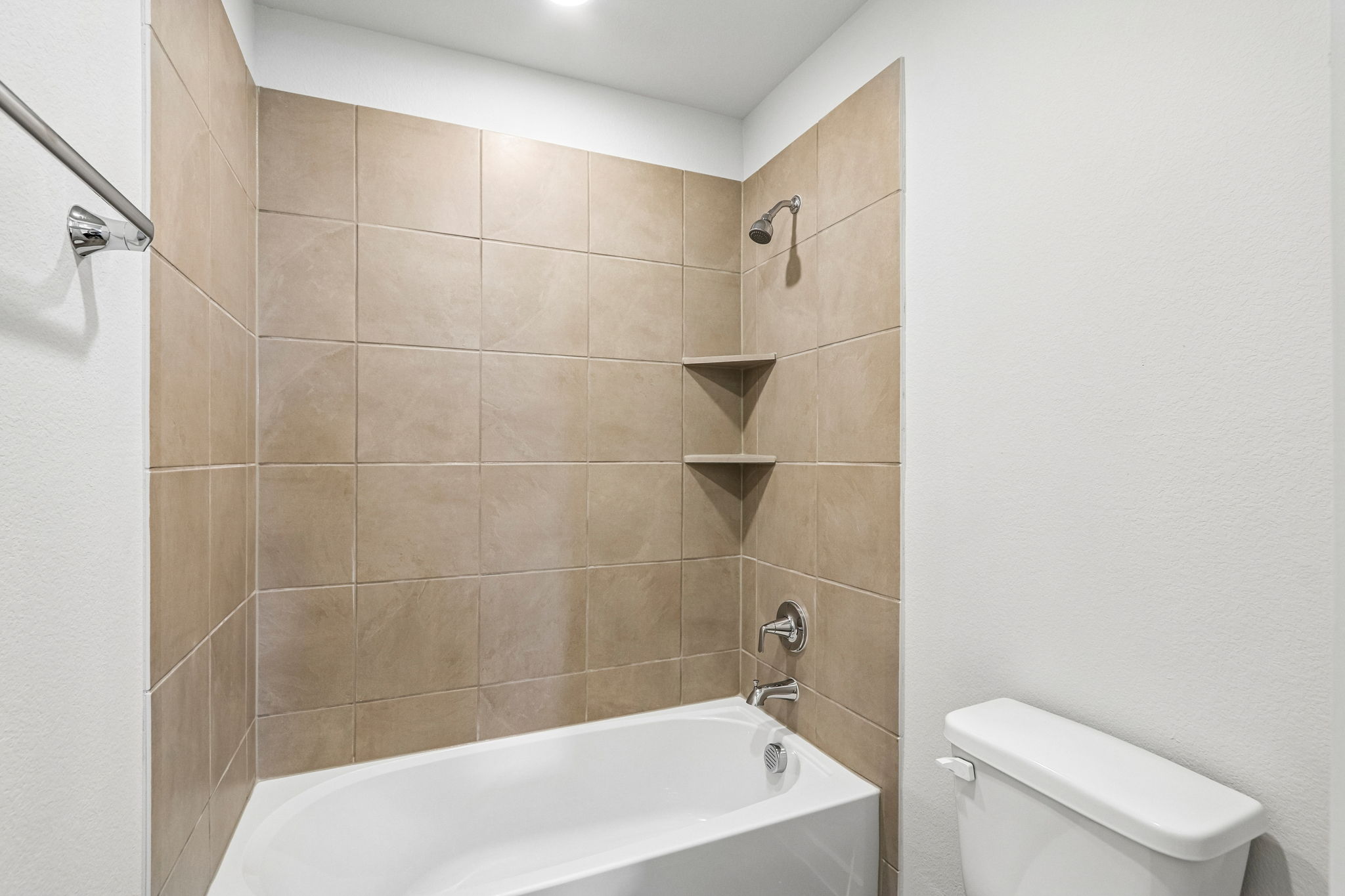 A bathroom with a bathtub and toilet.
