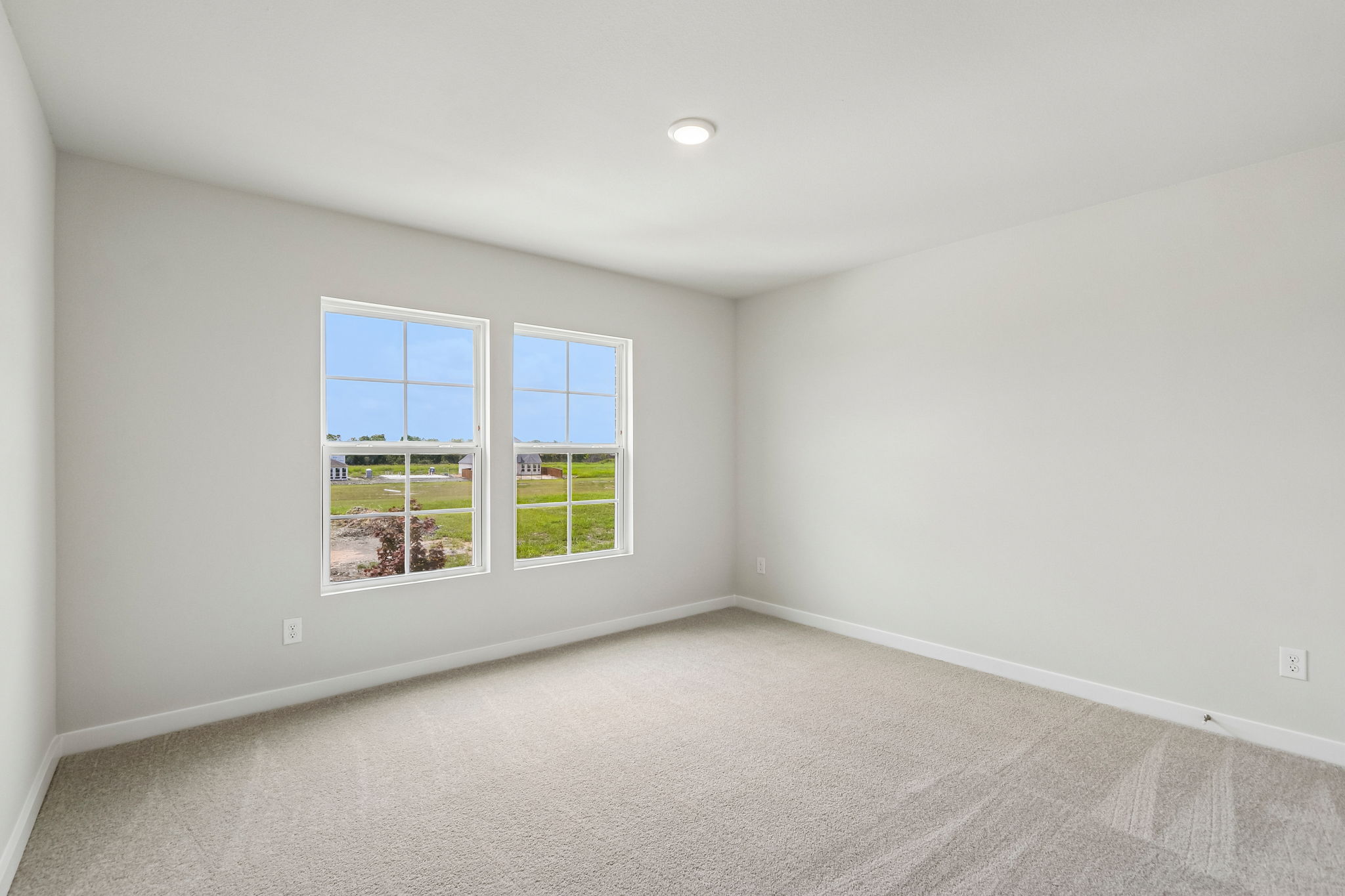 A room with a window and a carpet.