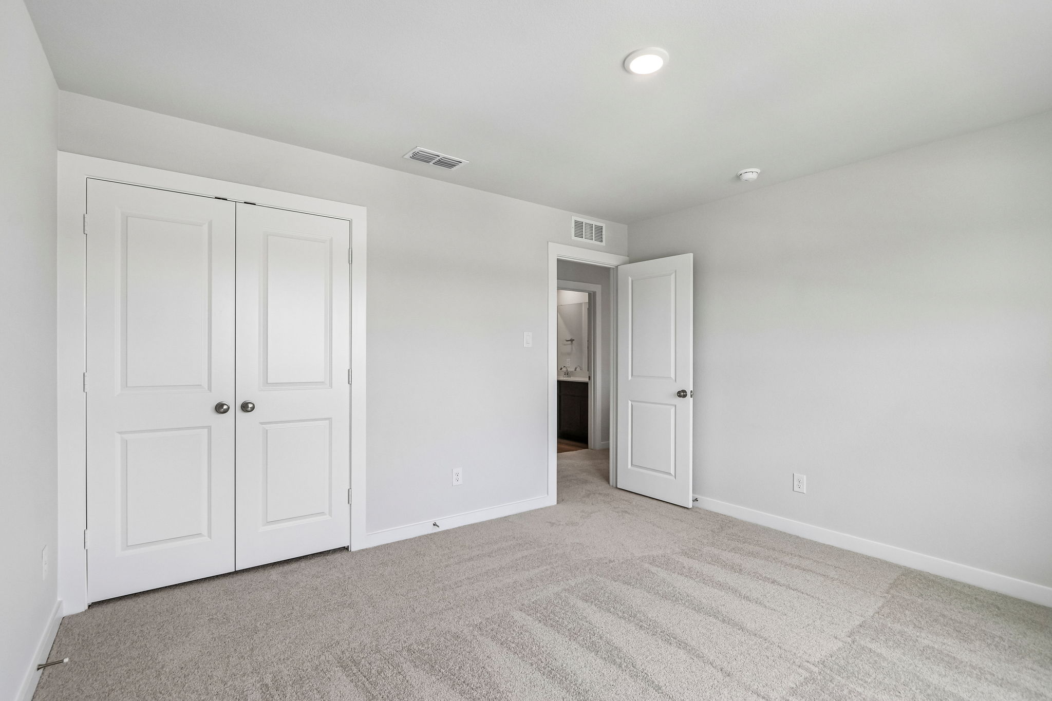 A hallway with white doors.