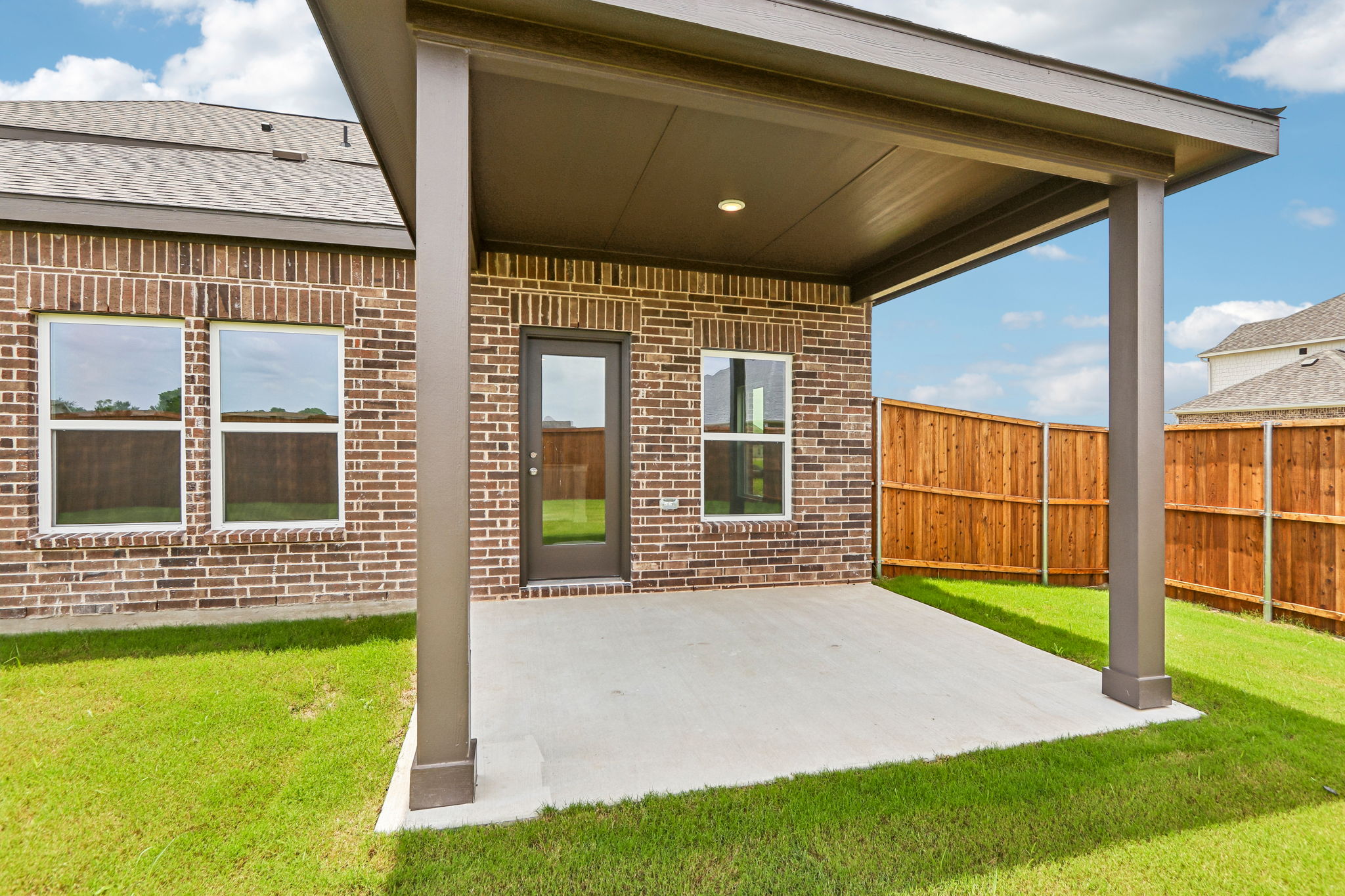 A brick house with a covered porch.