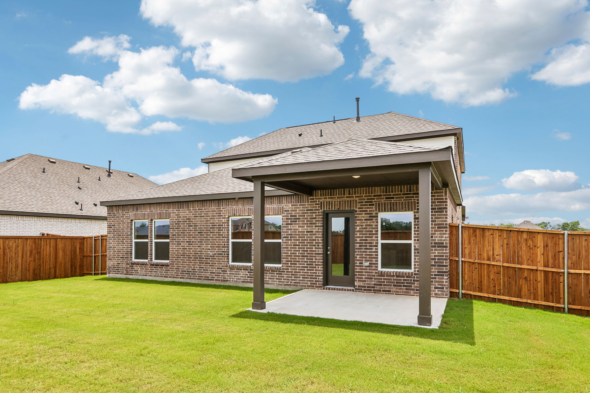 A house with a fence and grass.