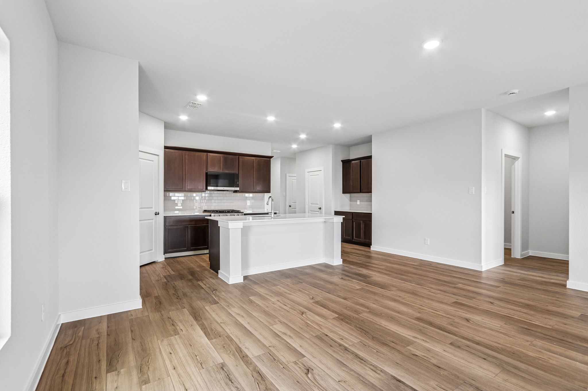 A kitchen with wooden floors.