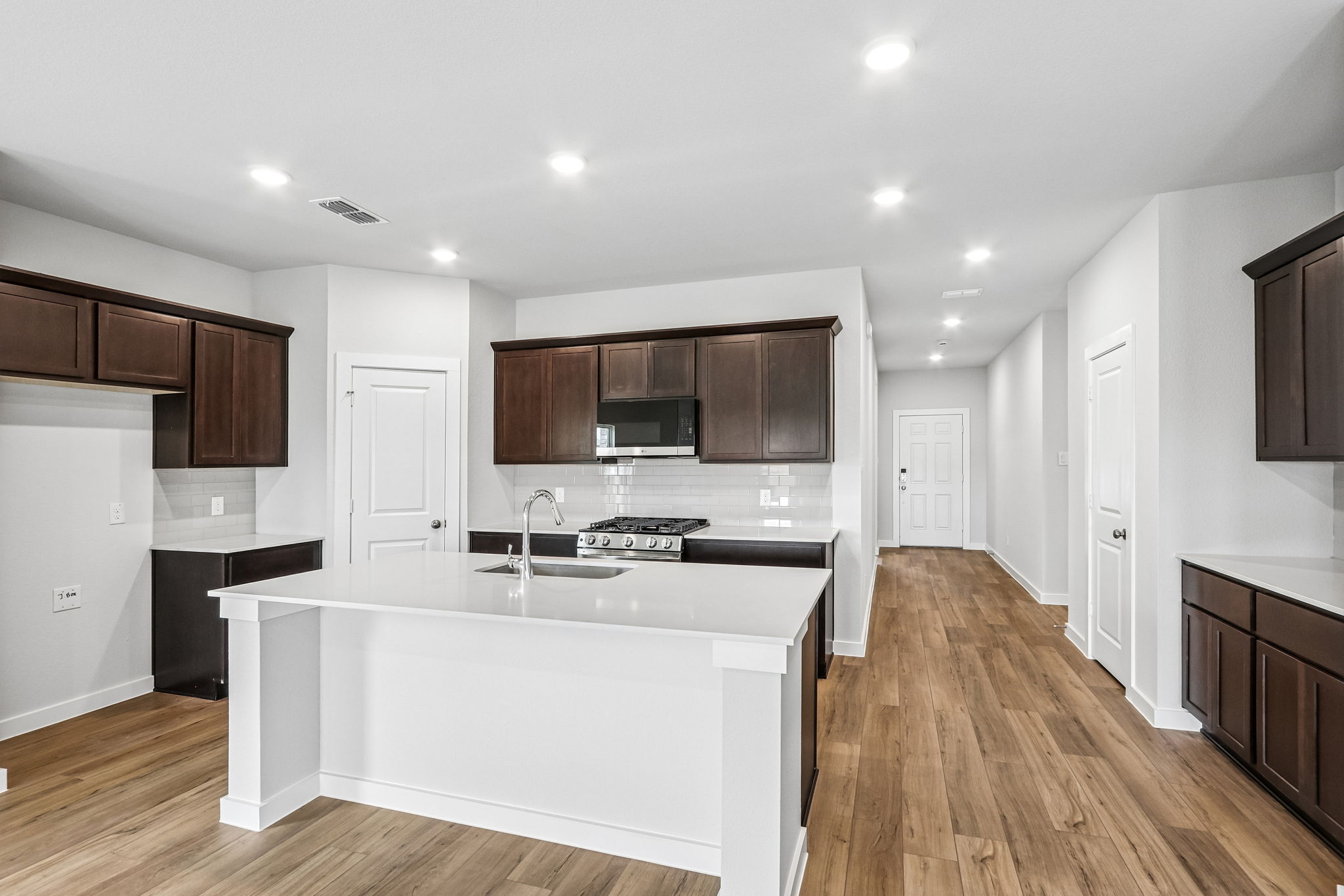 A kitchen with wooden cabinets.