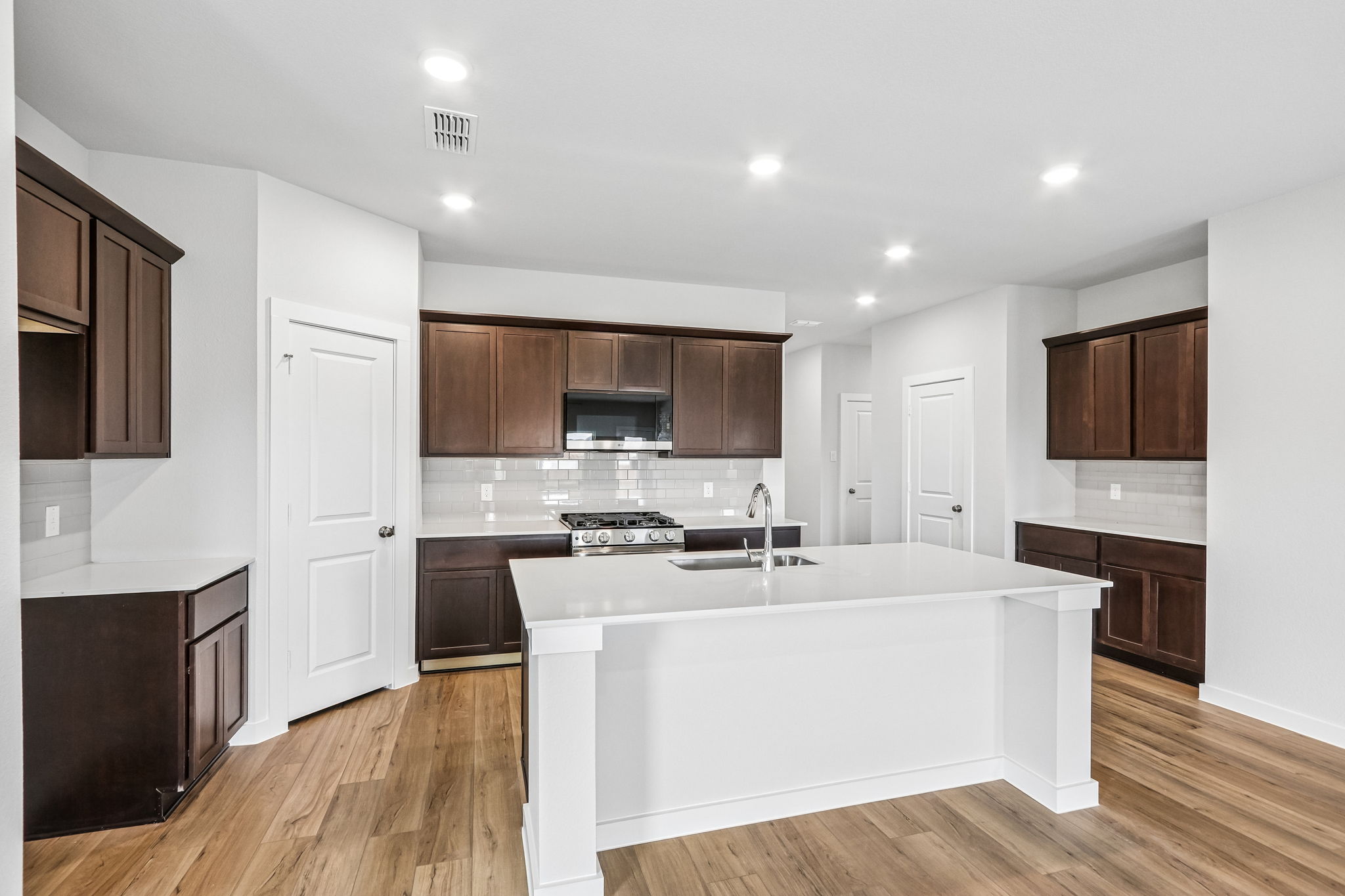 A large kitchen with a large white tub.