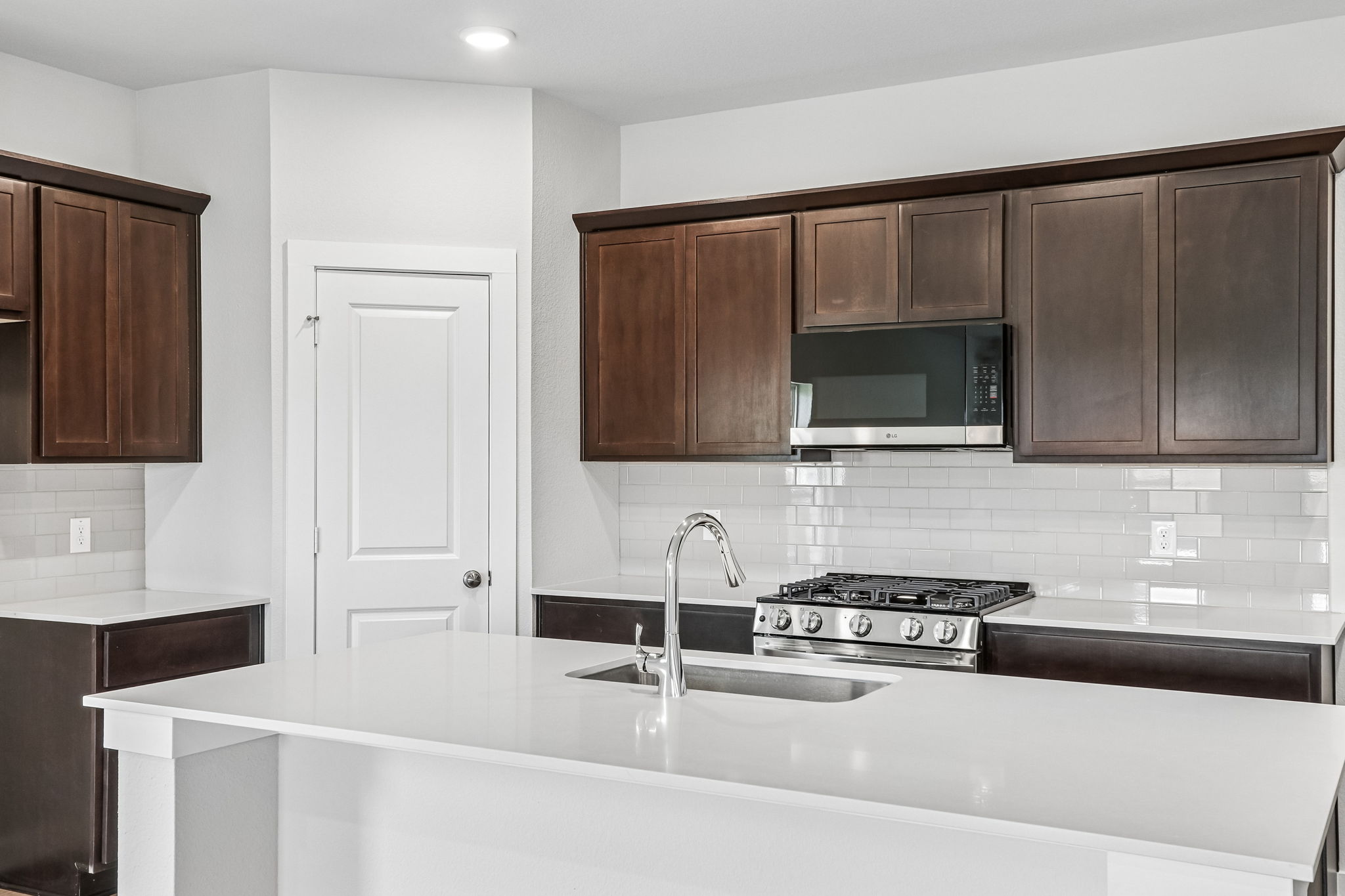 A kitchen with wooden cabinets.