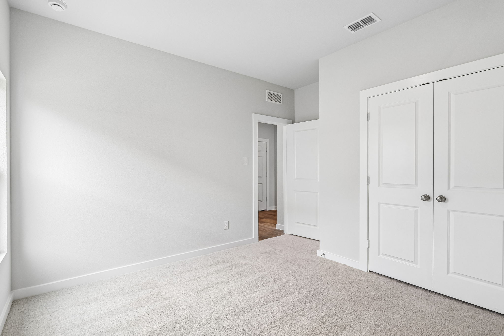 A hallway with white doors.
