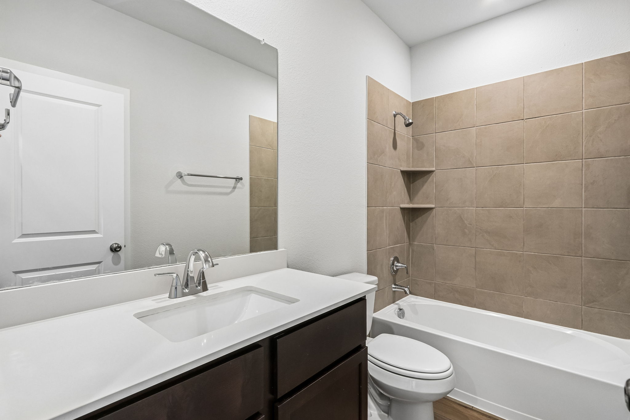 A bathroom with a tub sink and toilet.
