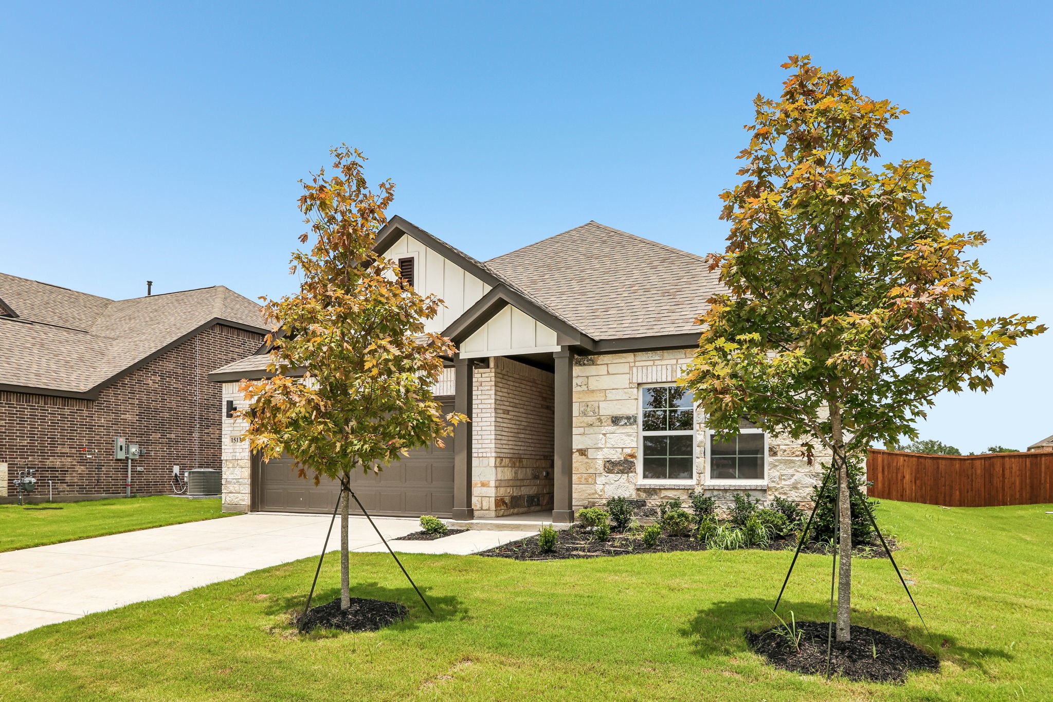 A house with trees in the front.