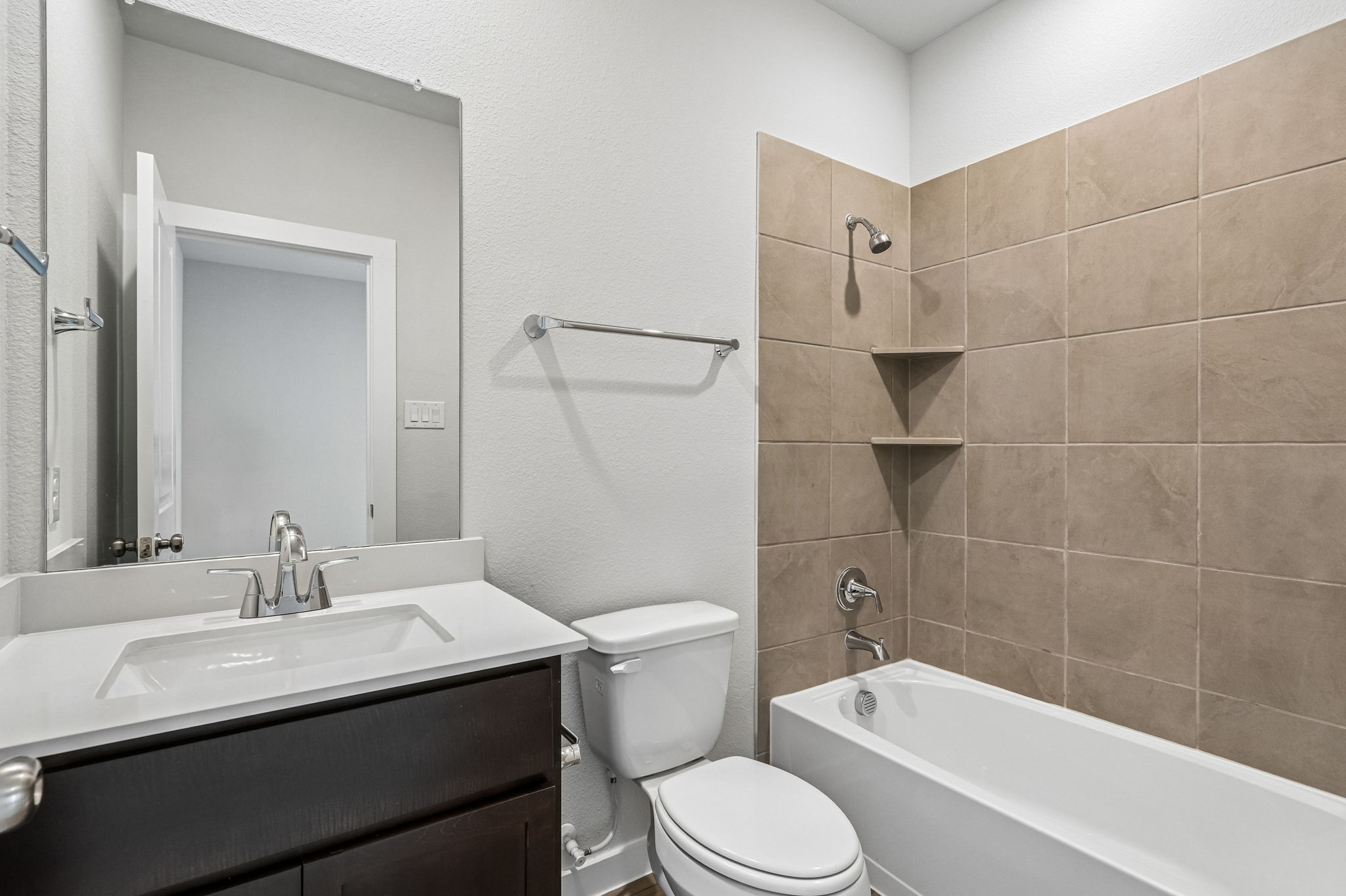 A bathroom with a tub toilet and sink.