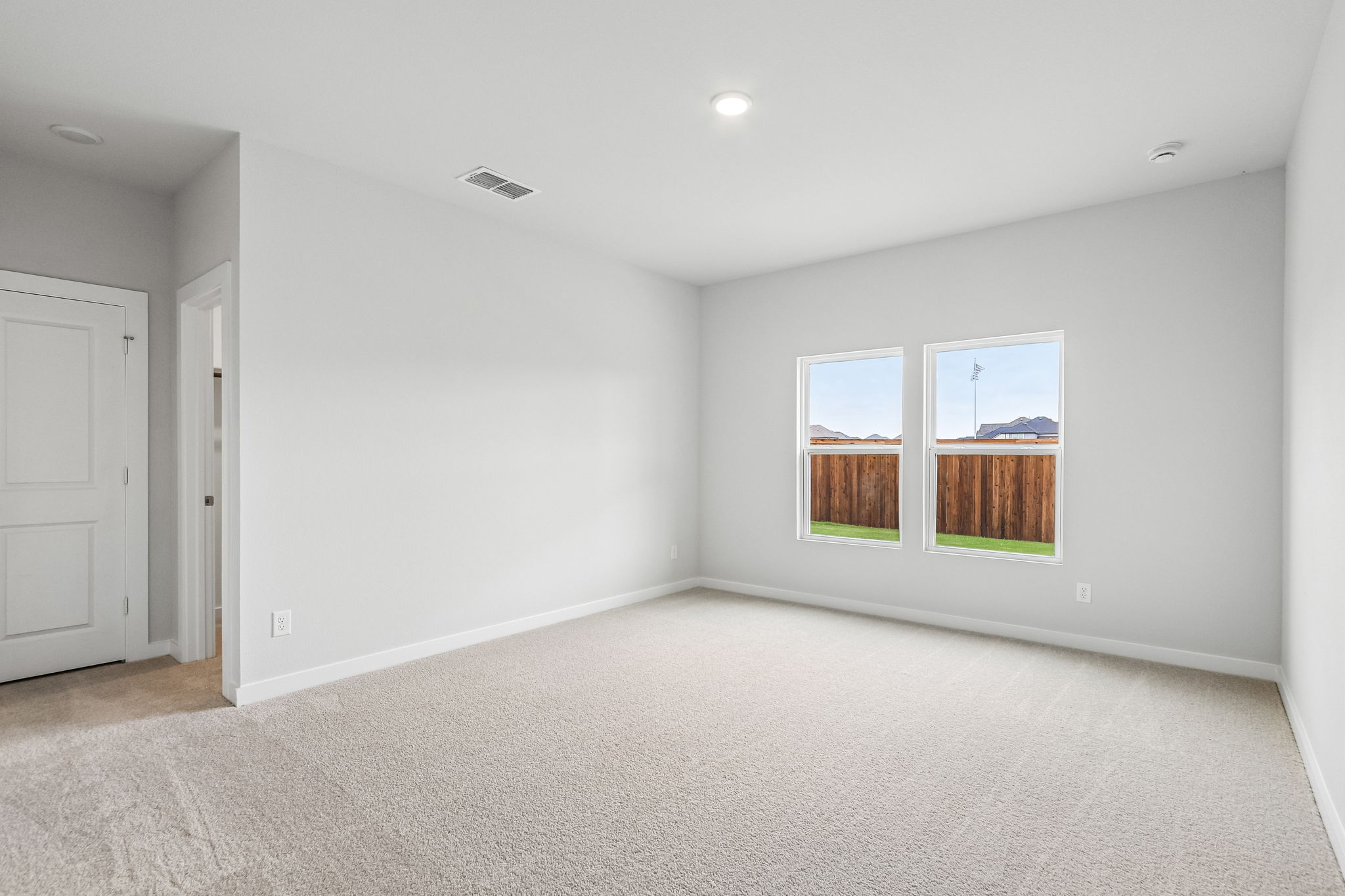 A room with a window and a carpet.