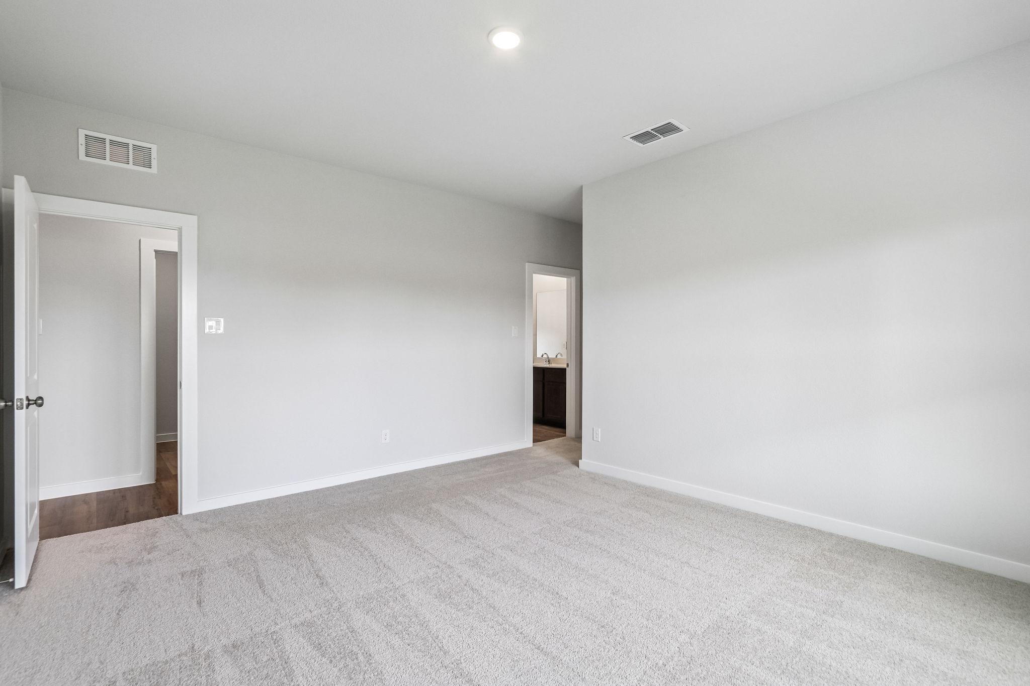 A hallway with white walls.