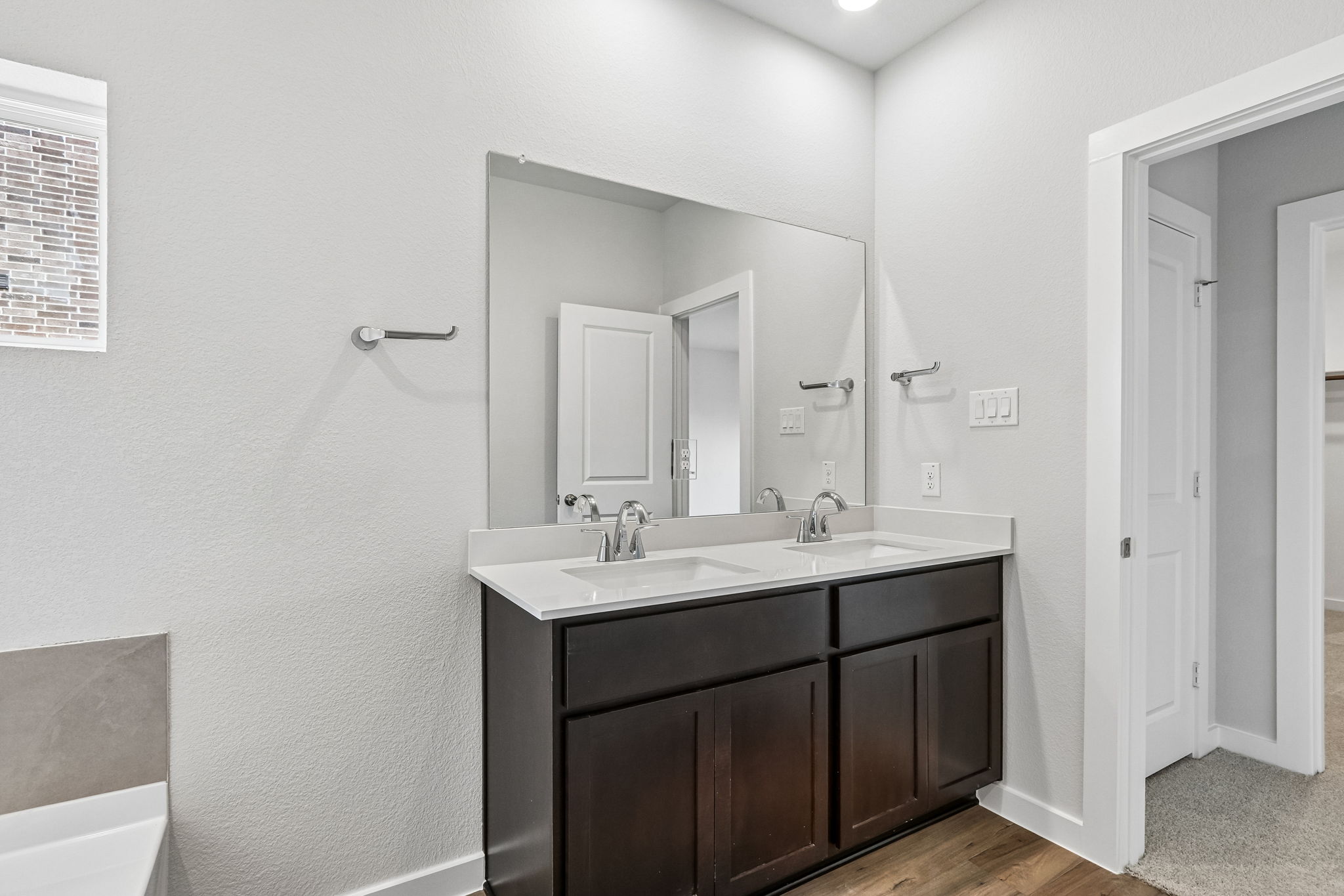 A bathroom with a large mirror.