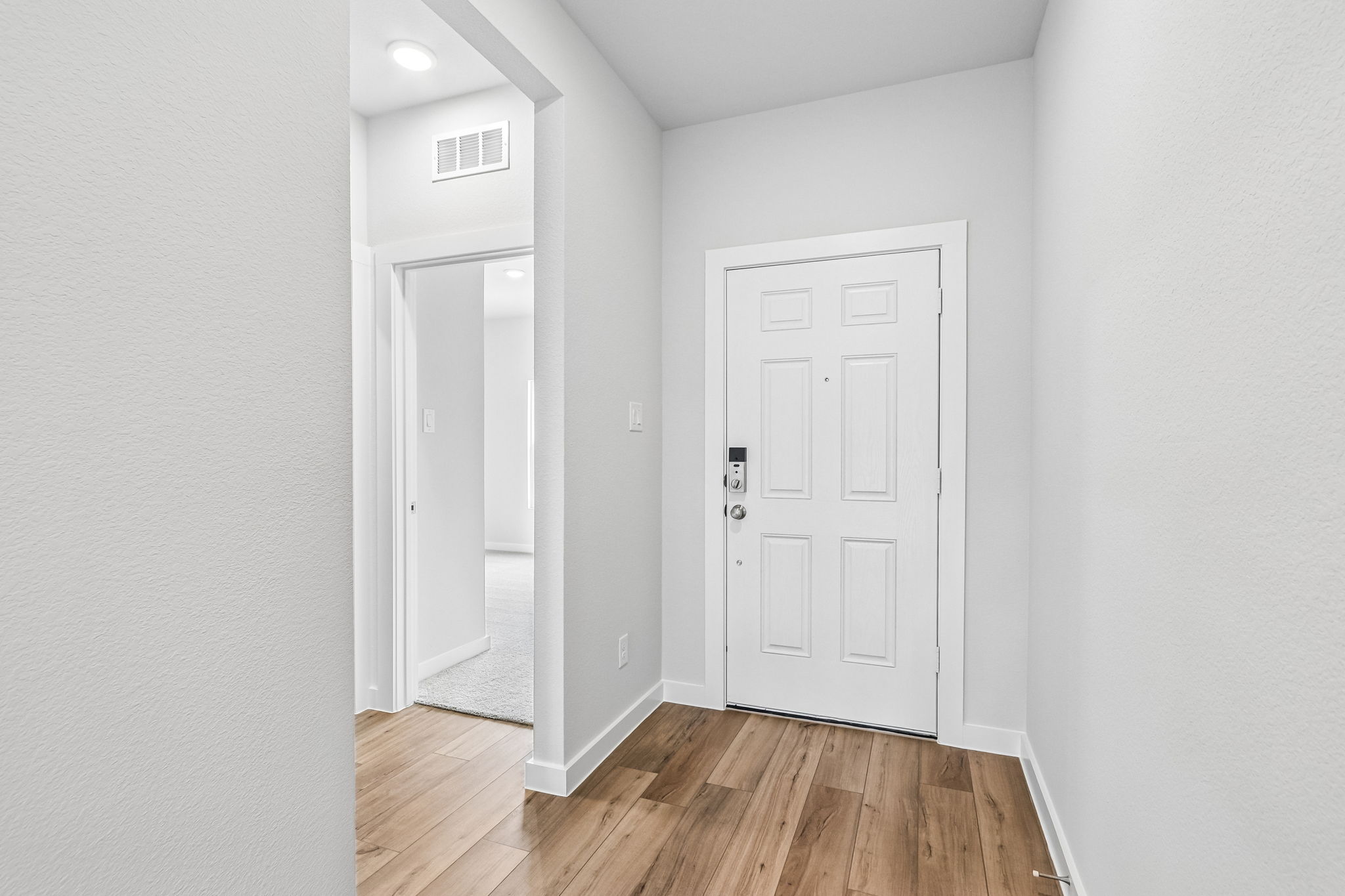 A hallway with white doors.