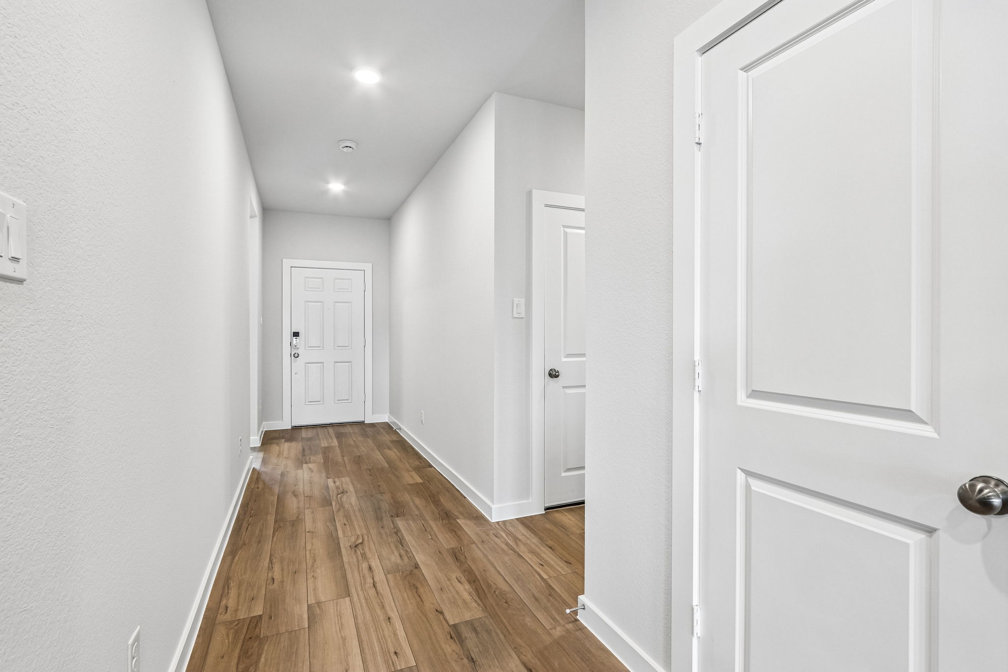 A hallway with white doors.