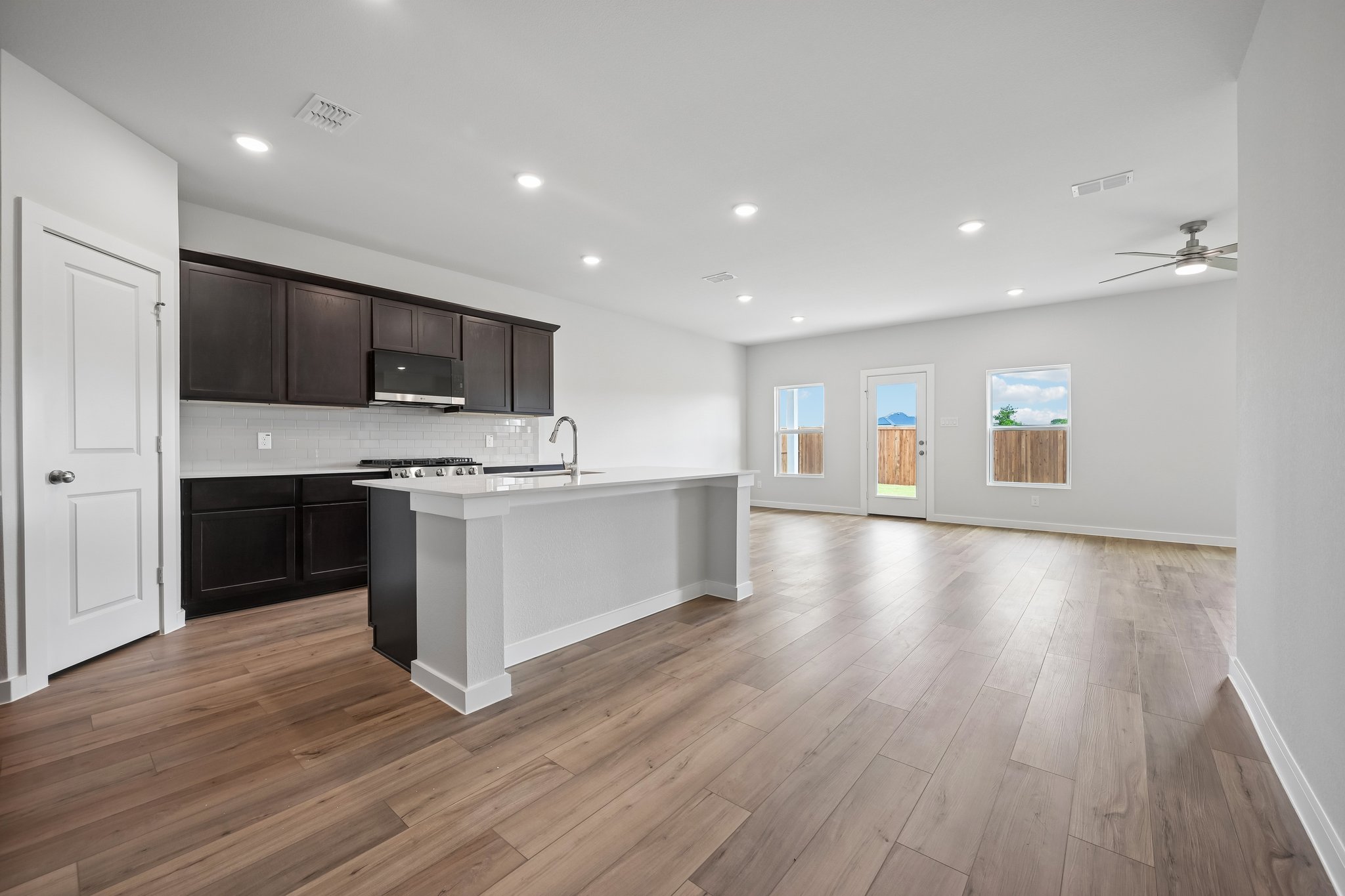 A kitchen with black cabinets.