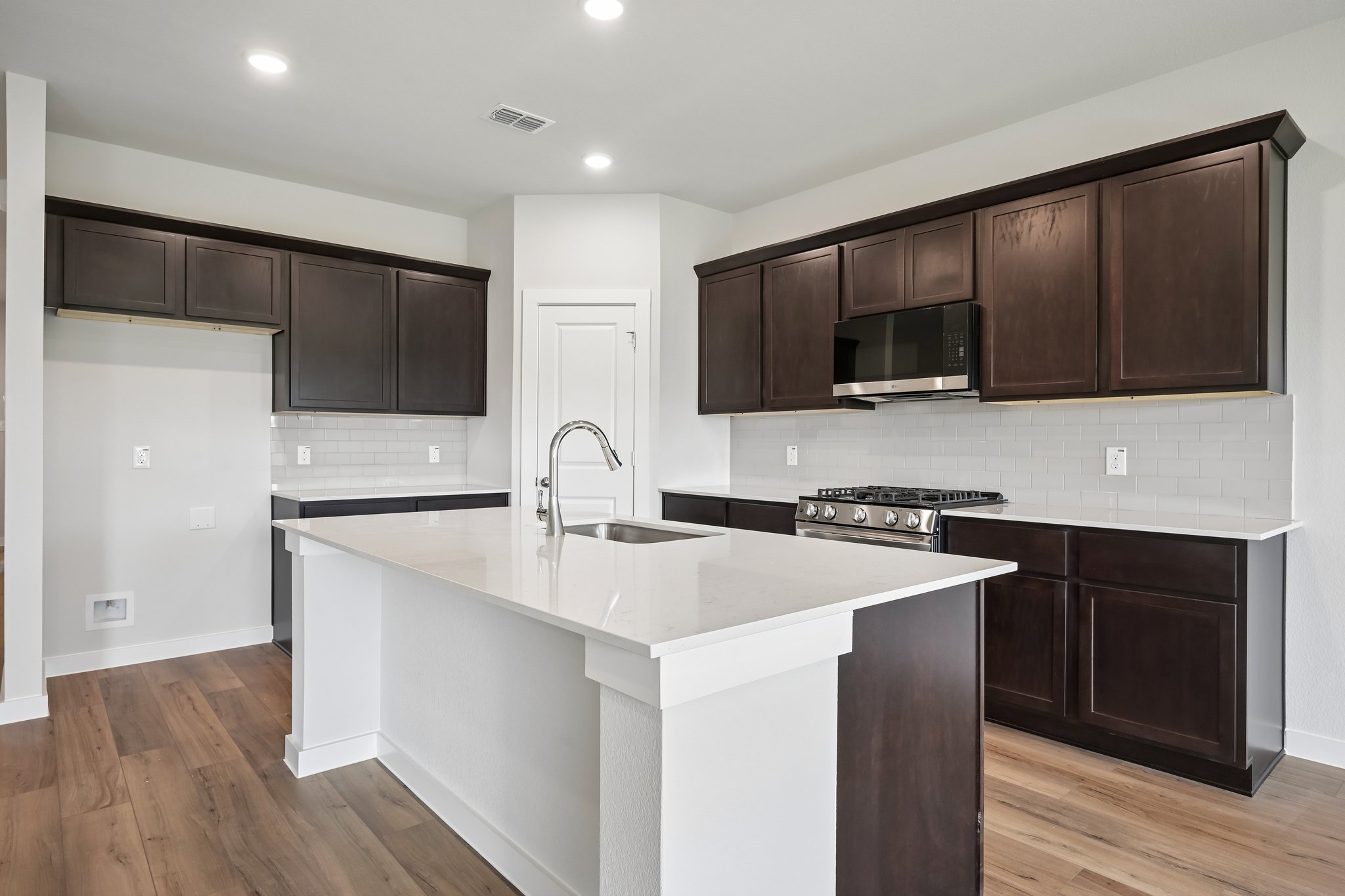 A kitchen with black cabinets.