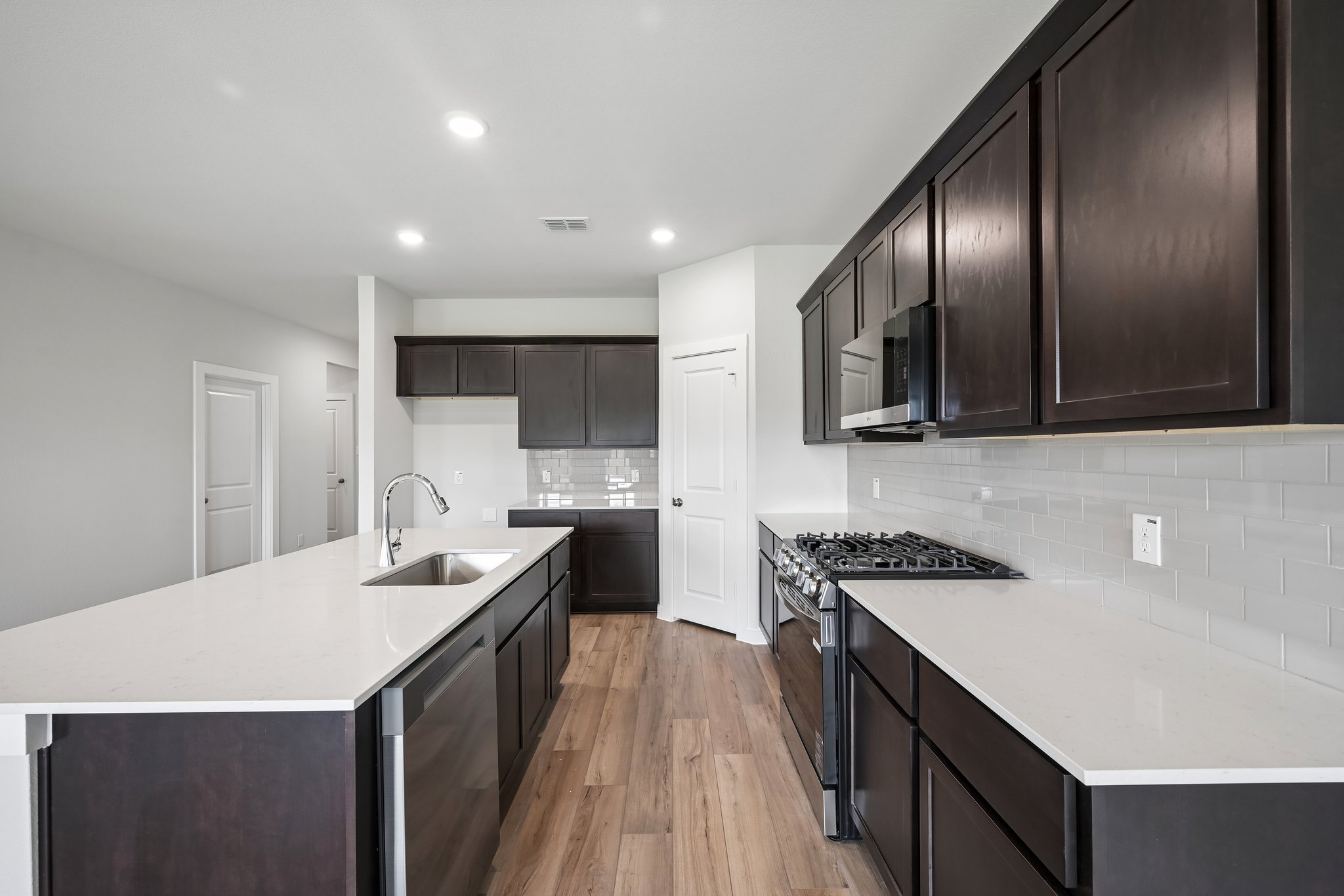 A kitchen with black cabinets.