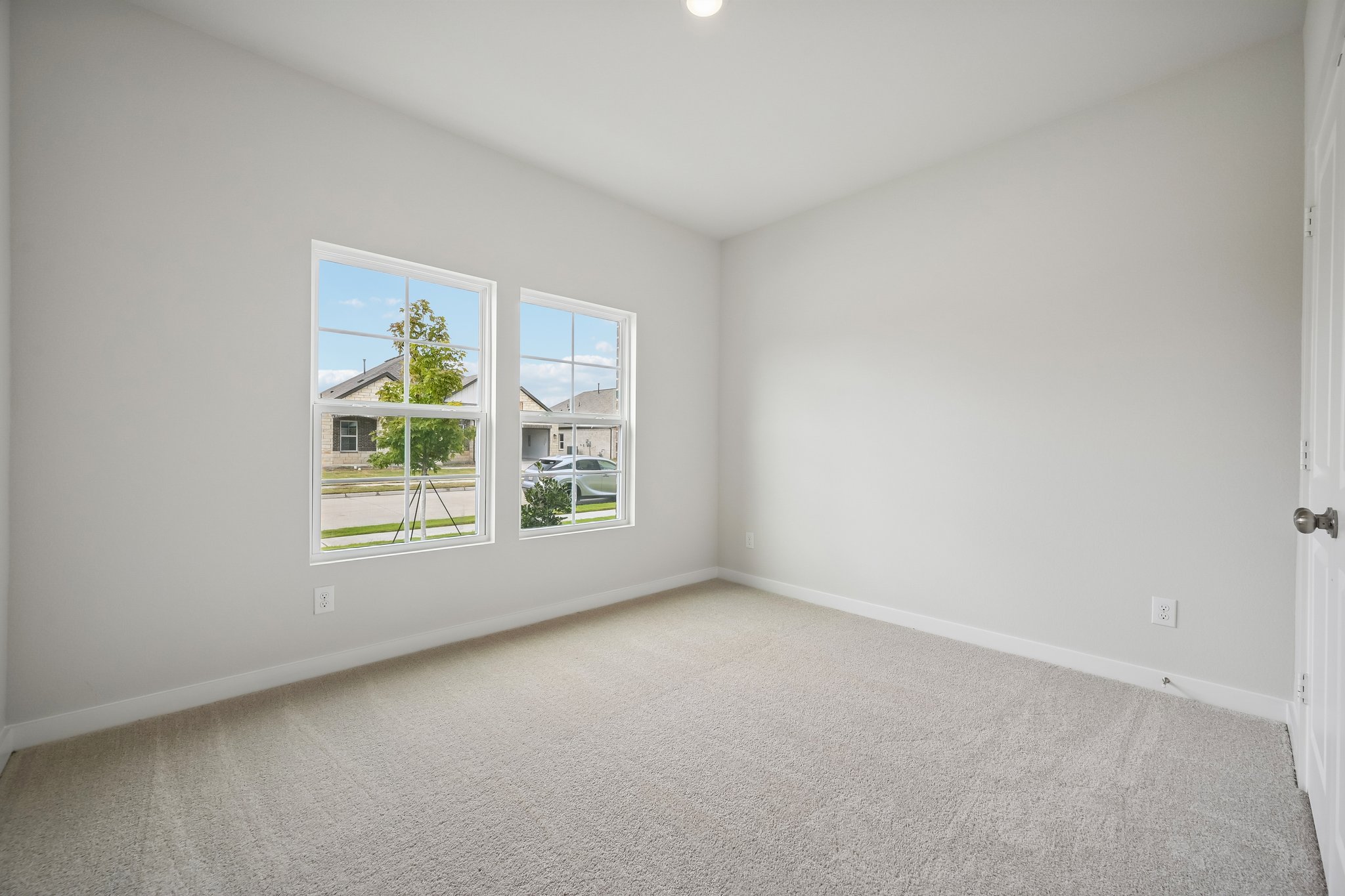A room with a window and a door.