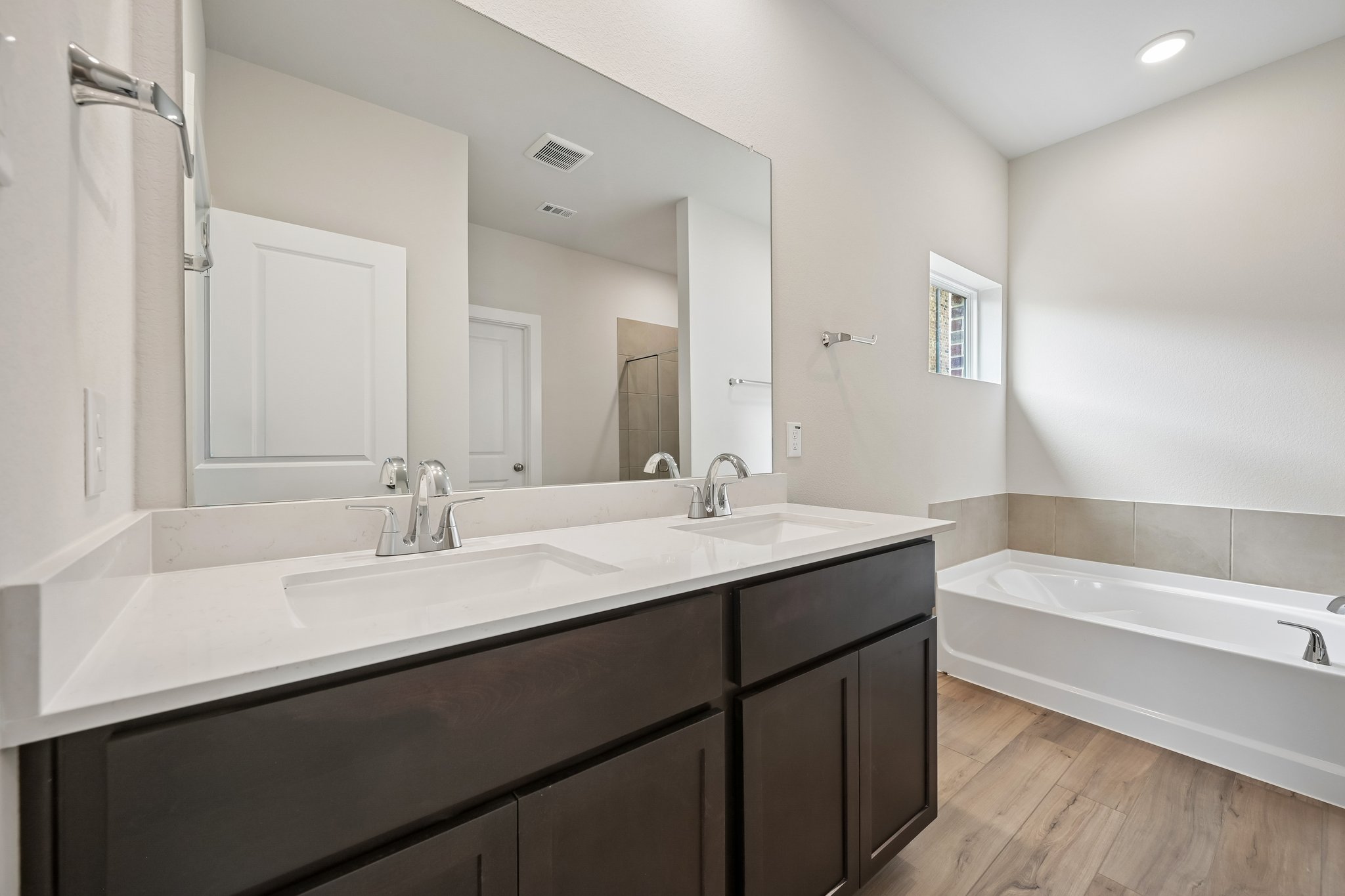 A bathroom with a large mirror.