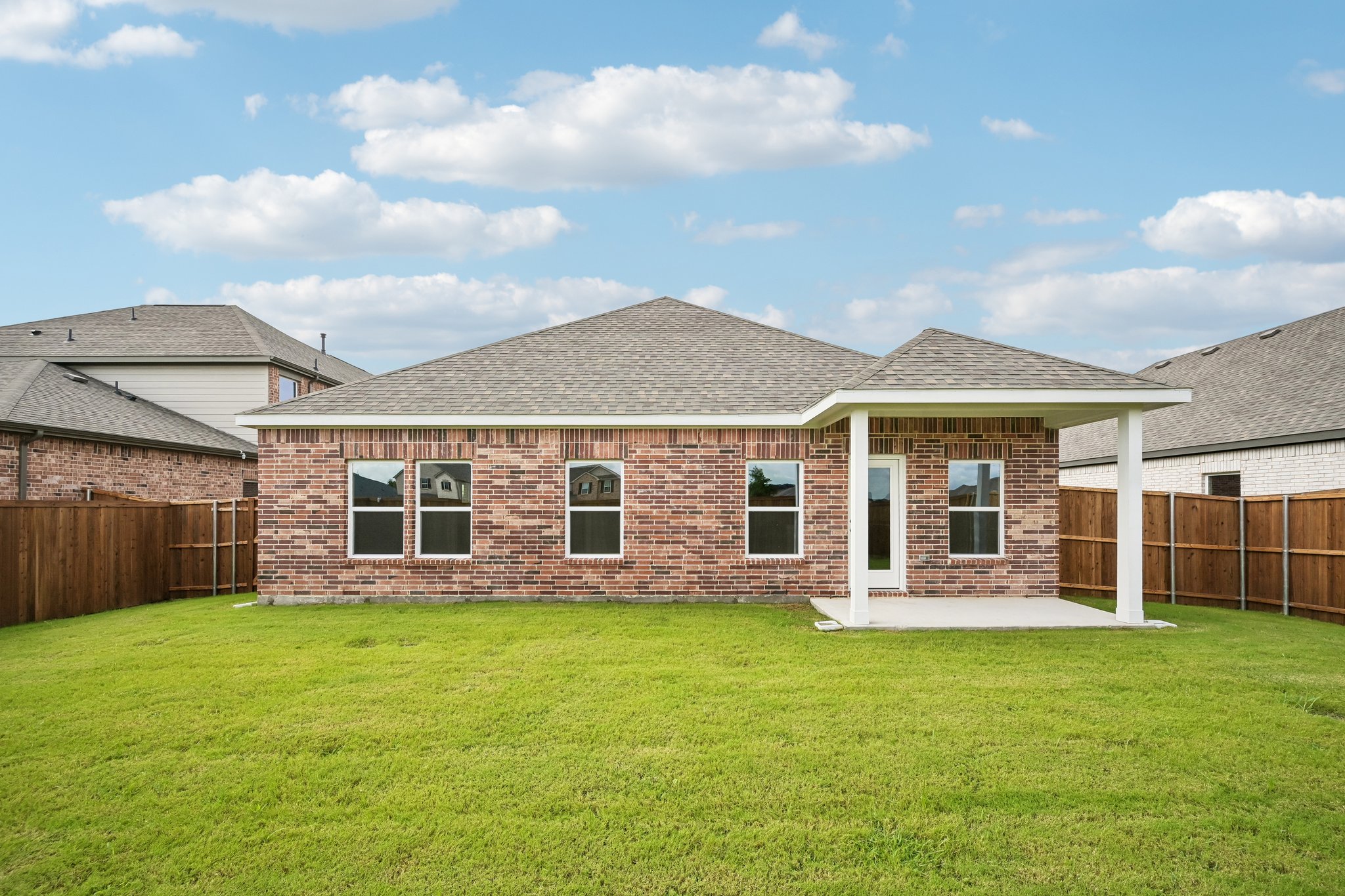 A house with a fence and grass.