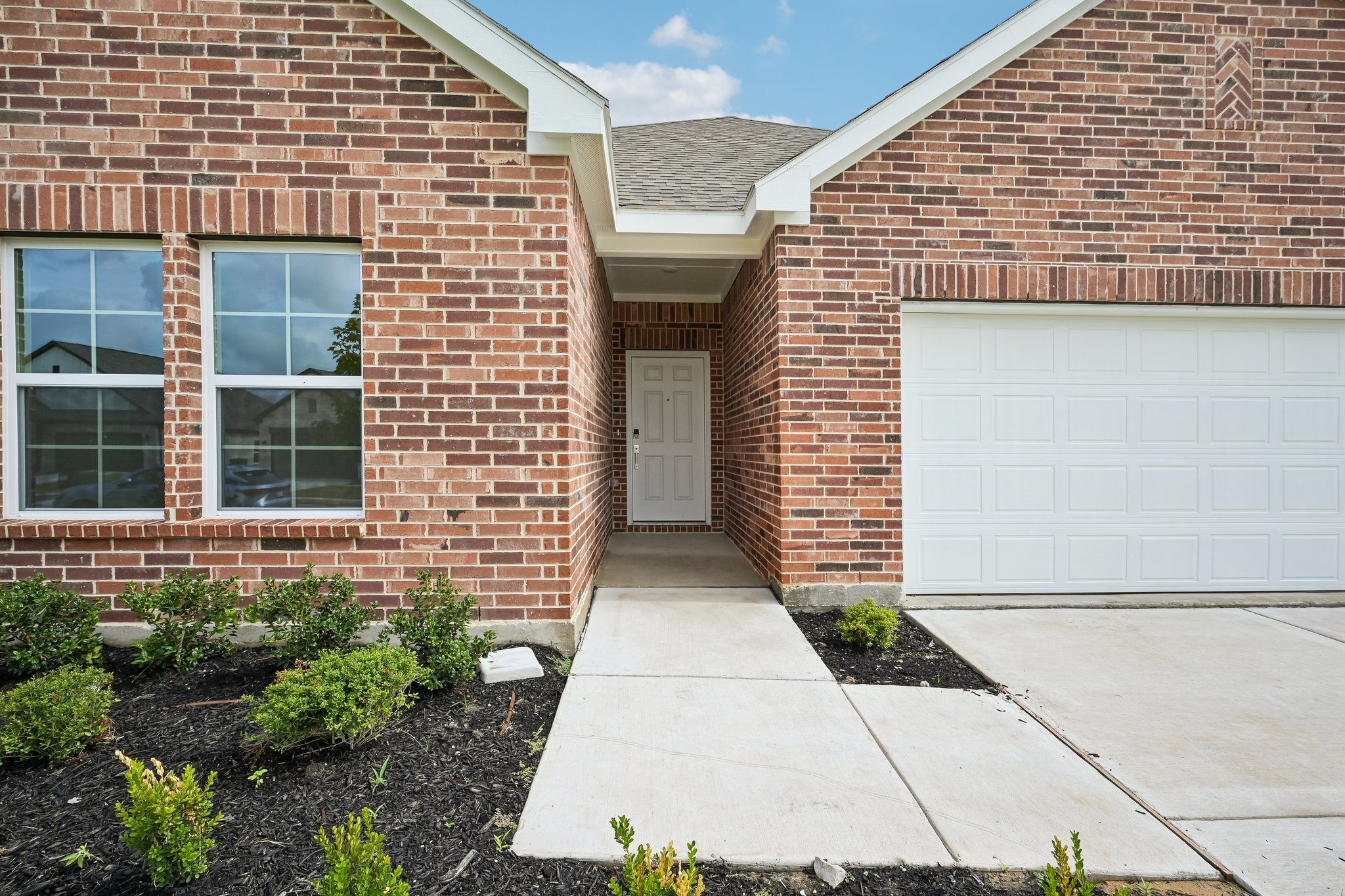 A brick building with a garage.