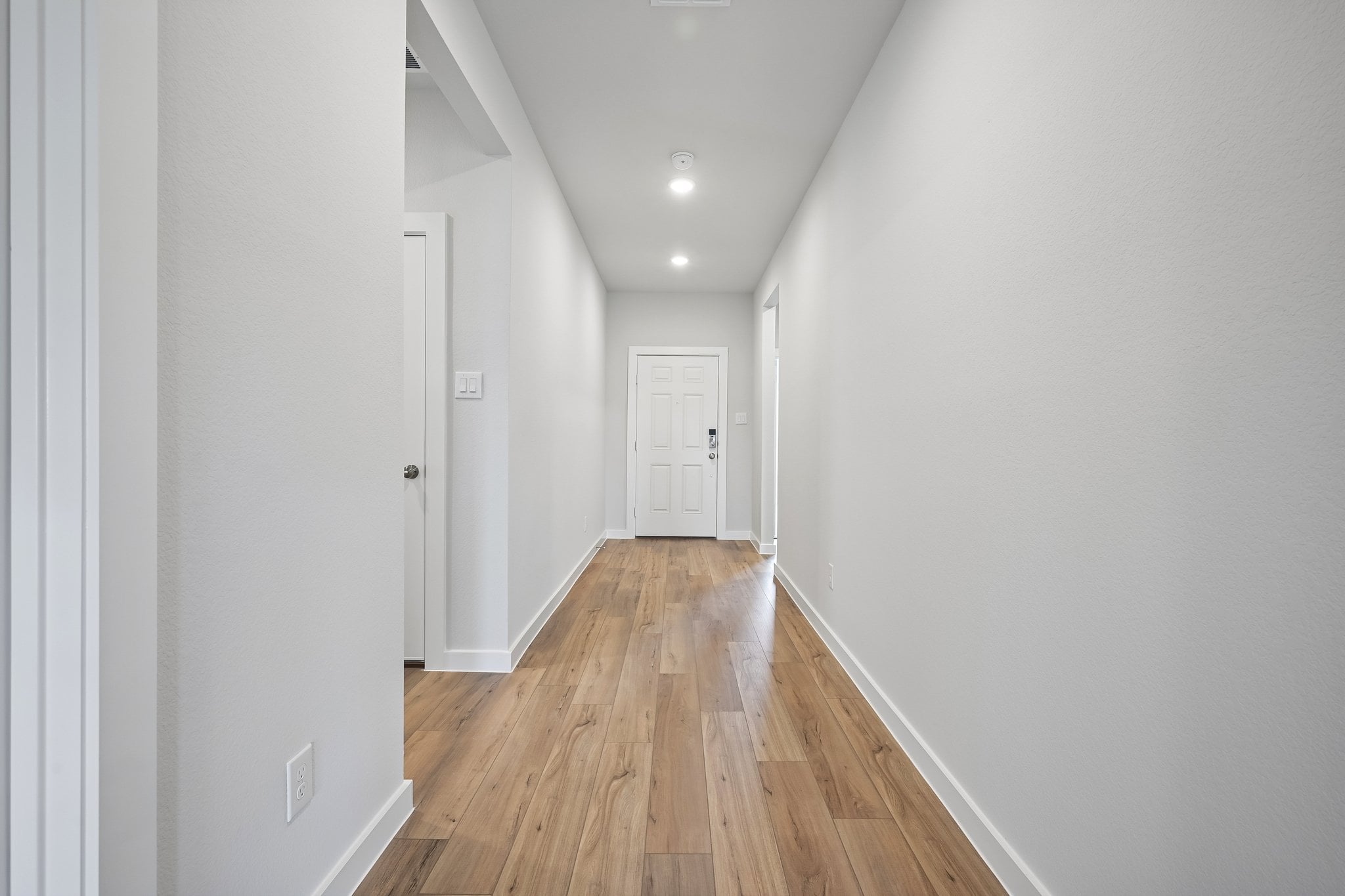 A hallway with white doors.