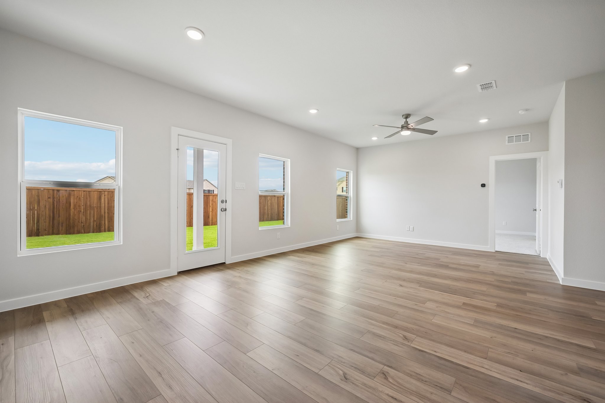 A room with a wood floor and a wood floor with a painting on the wall.
