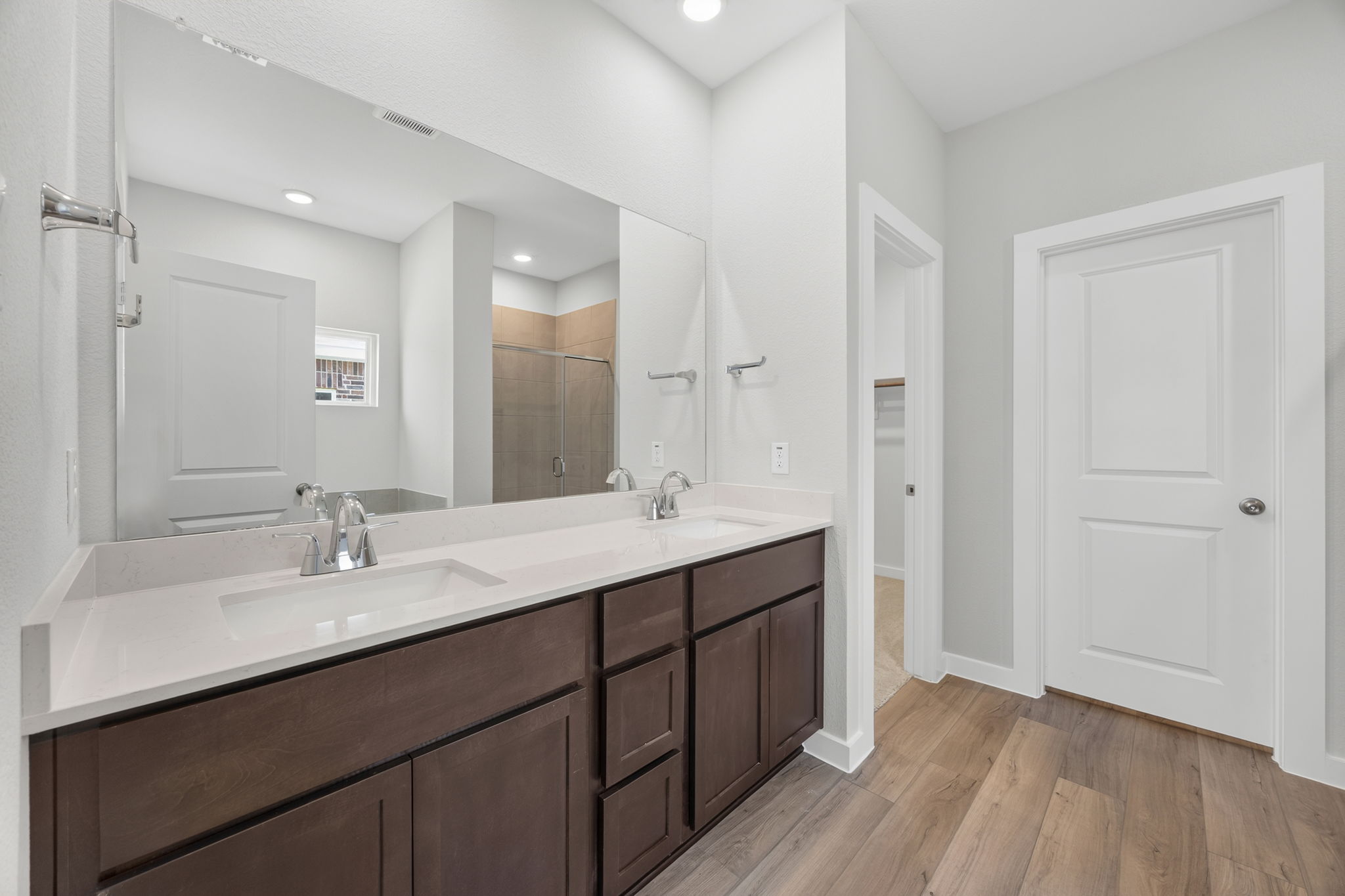 A bathroom with a large mirror.