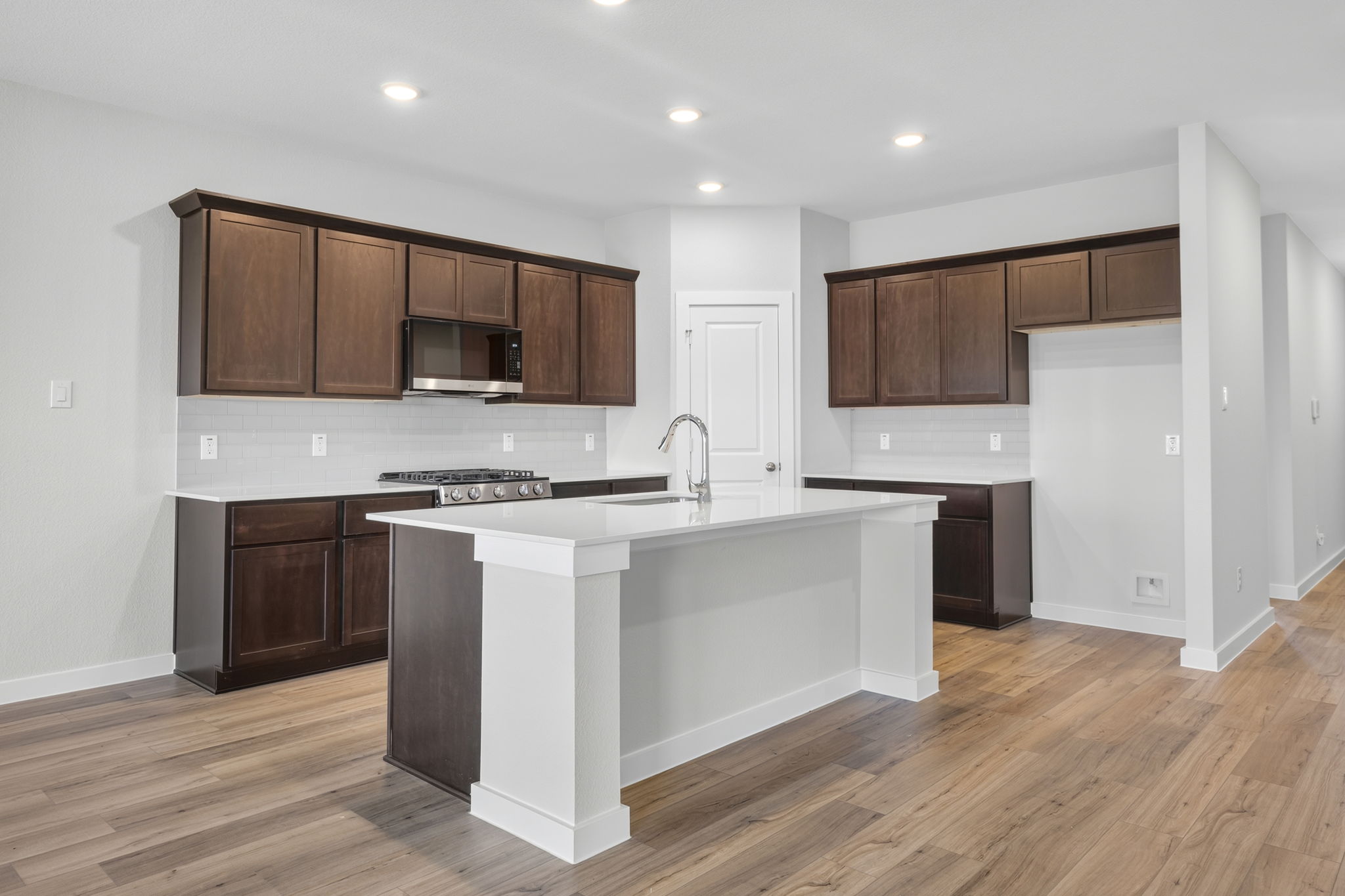 A kitchen with wooden cabinets.