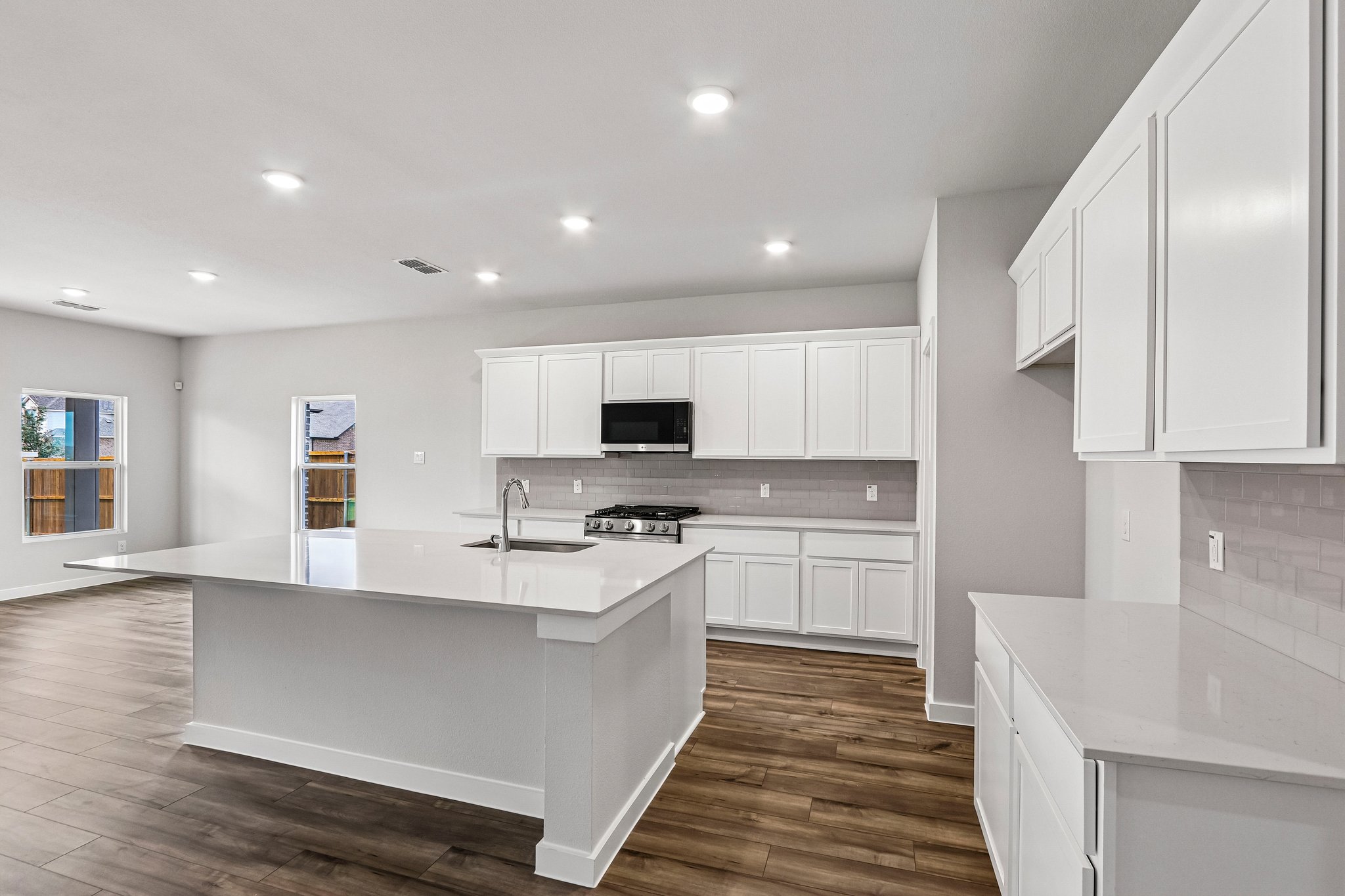 A kitchen with white cabinets.